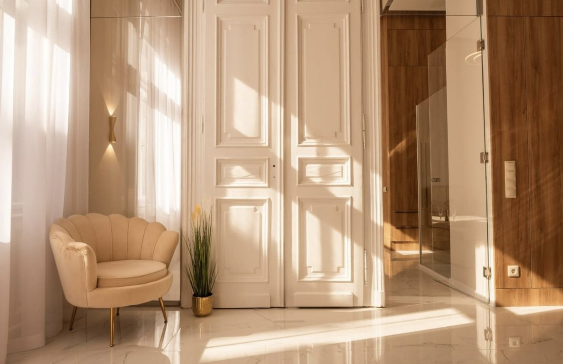 Sunlit room with armchair and doors