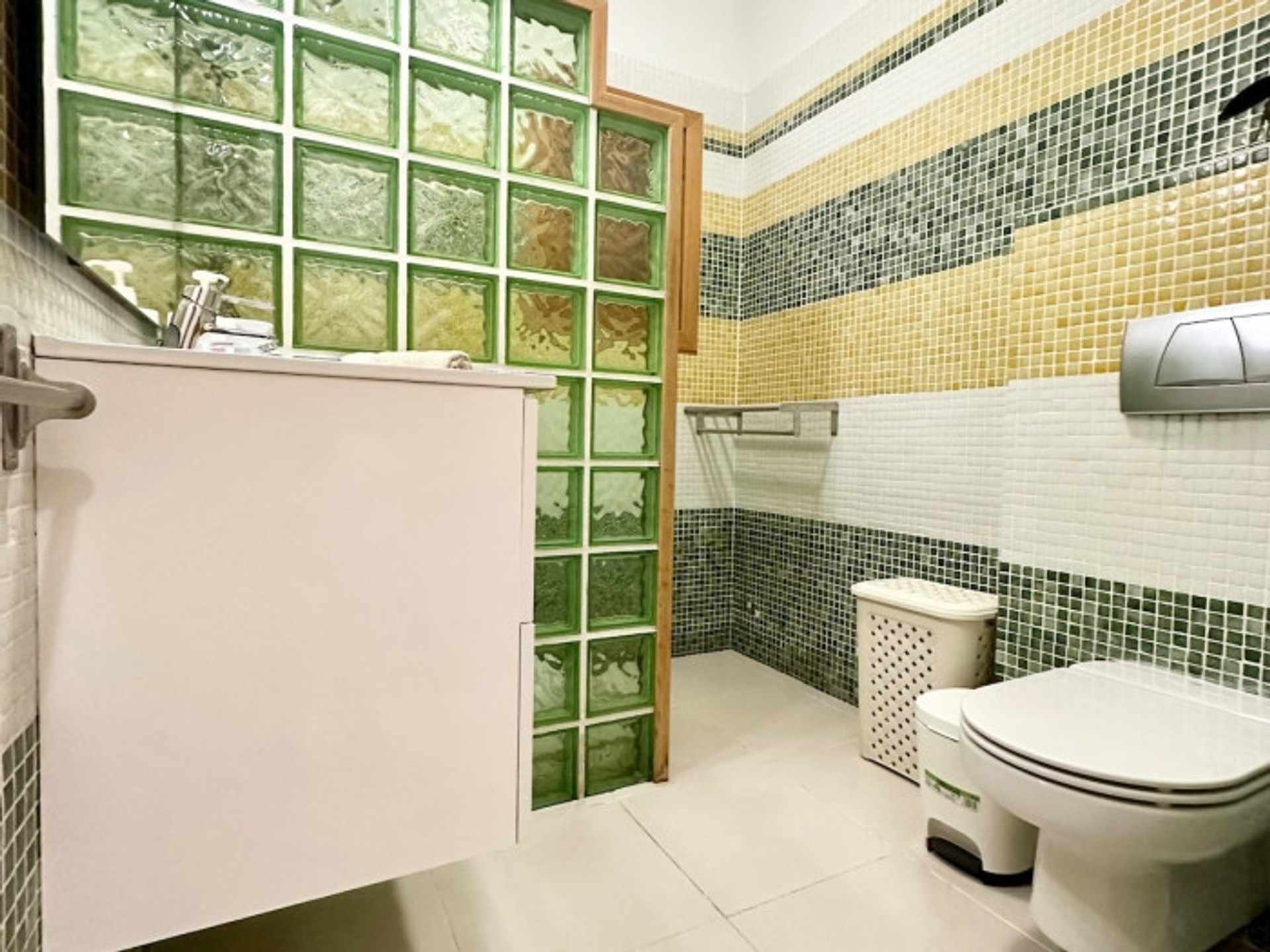Bathroom with green glass tiles