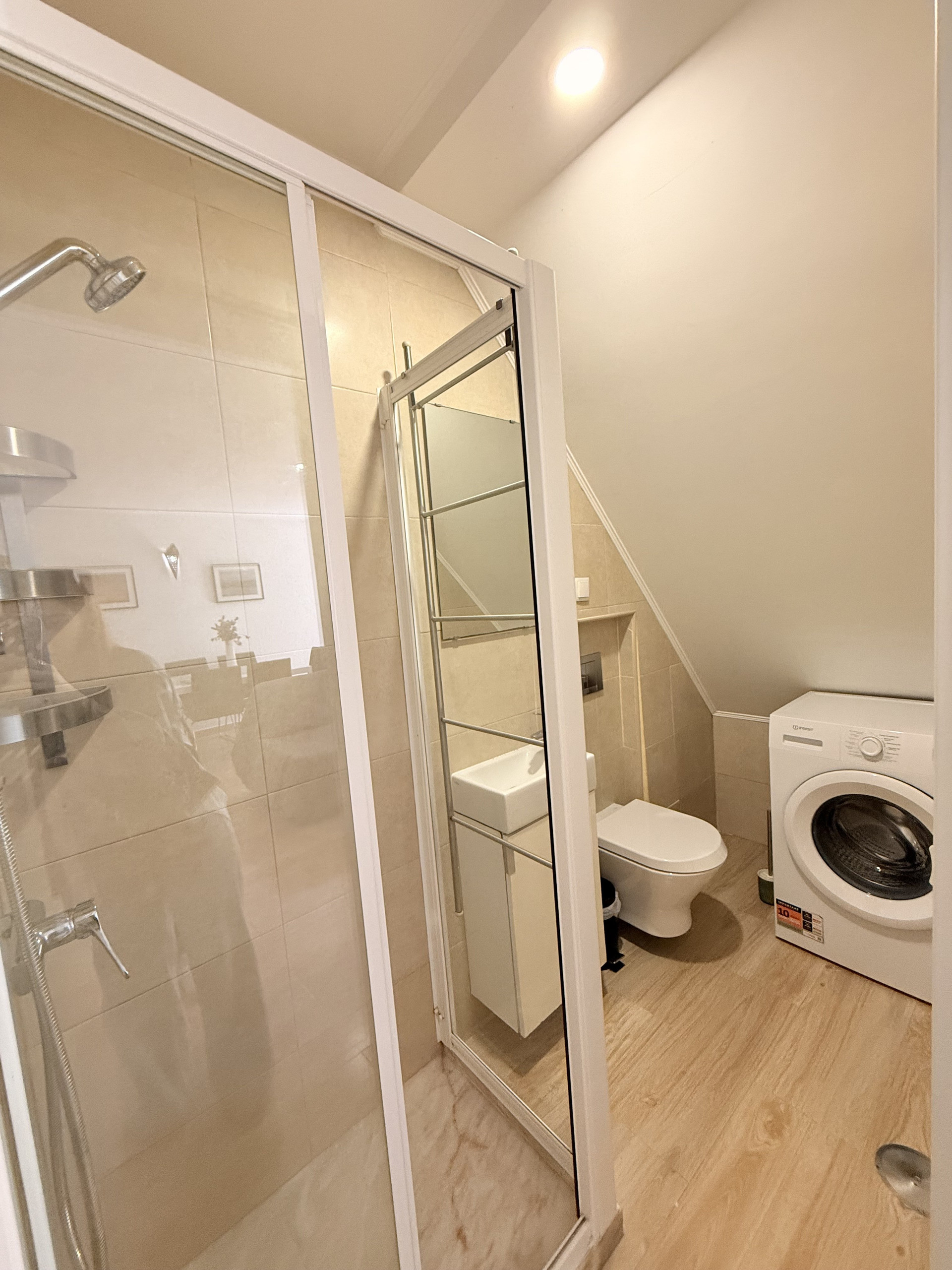 Bathroom with glass shower and washer