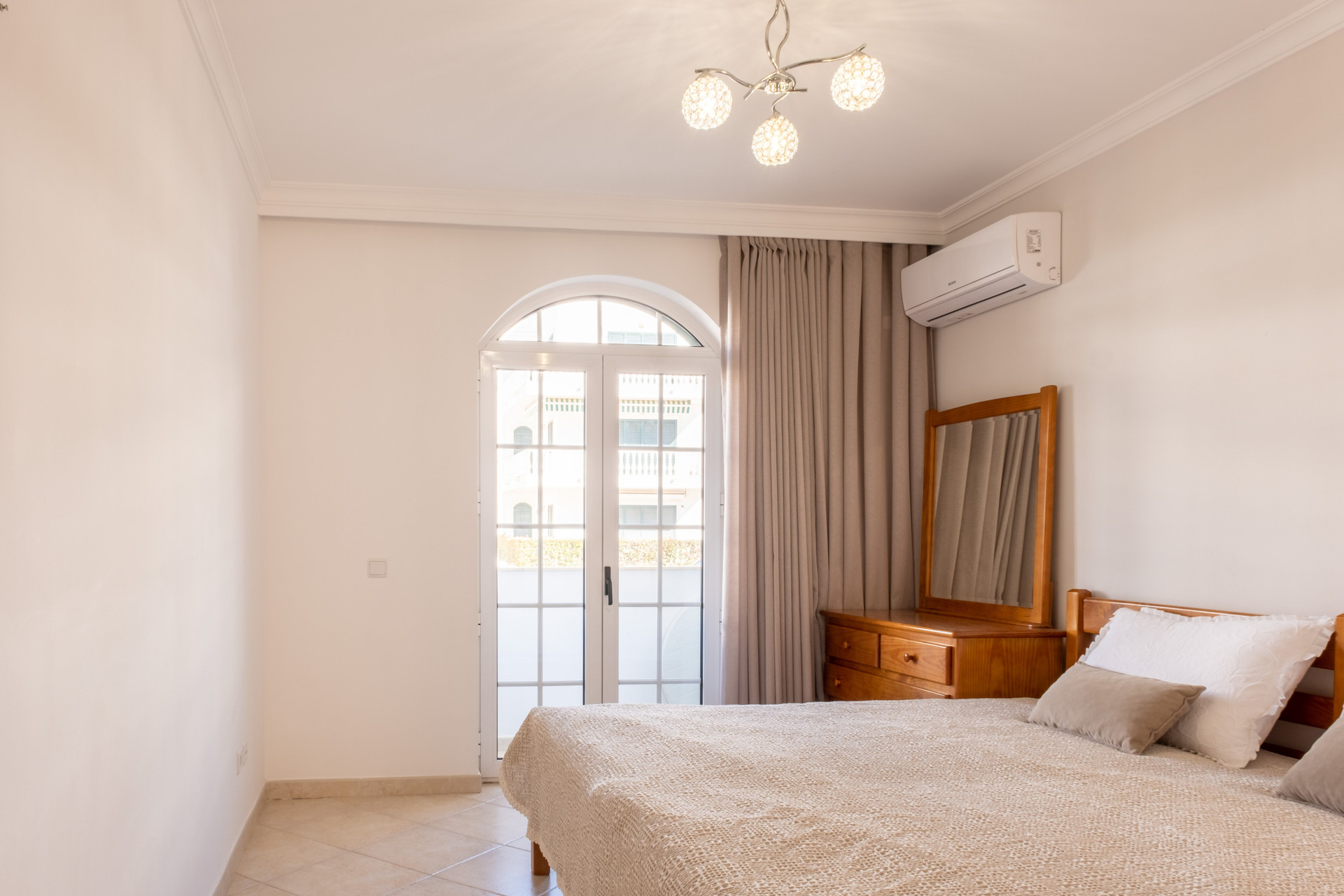 Bedroom with arched balcony door