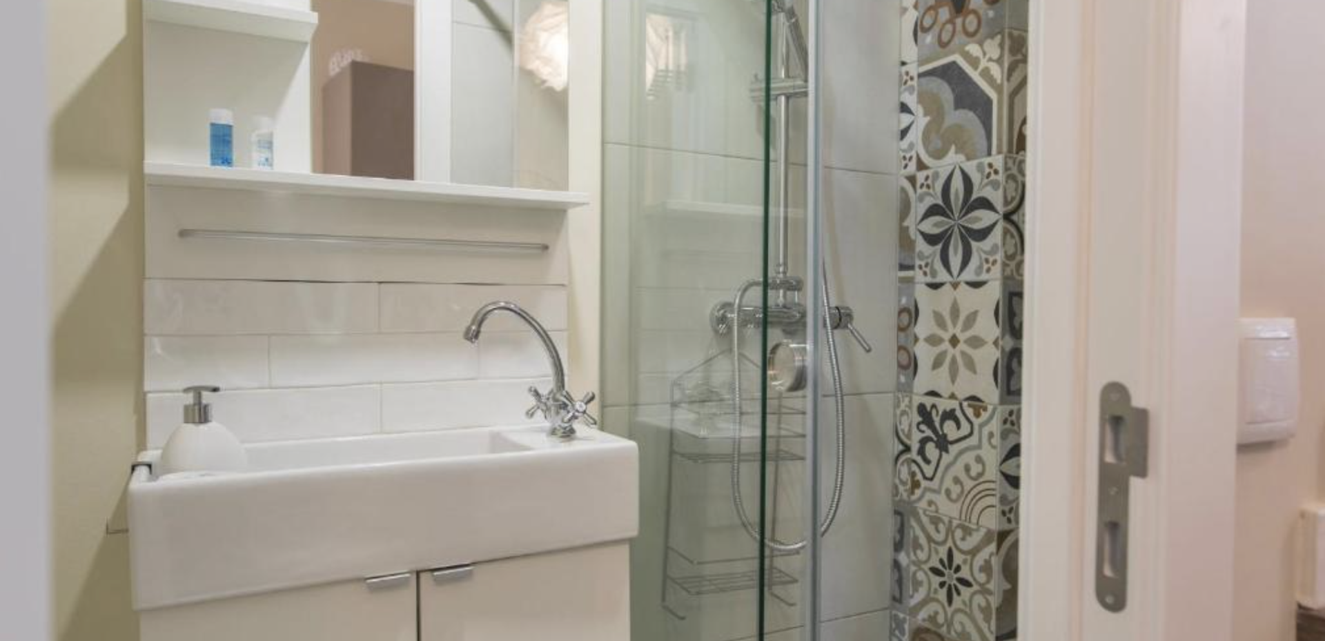 Bathroom with patterned tile shower
