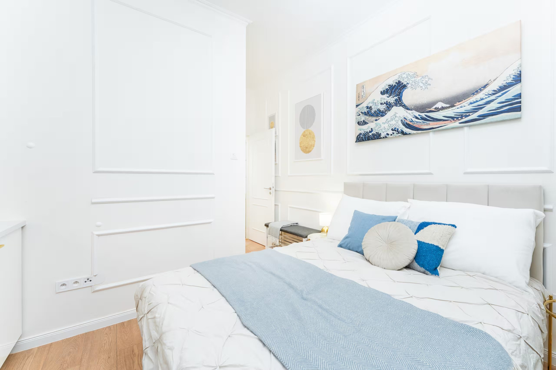 Bright bedroom with wave art