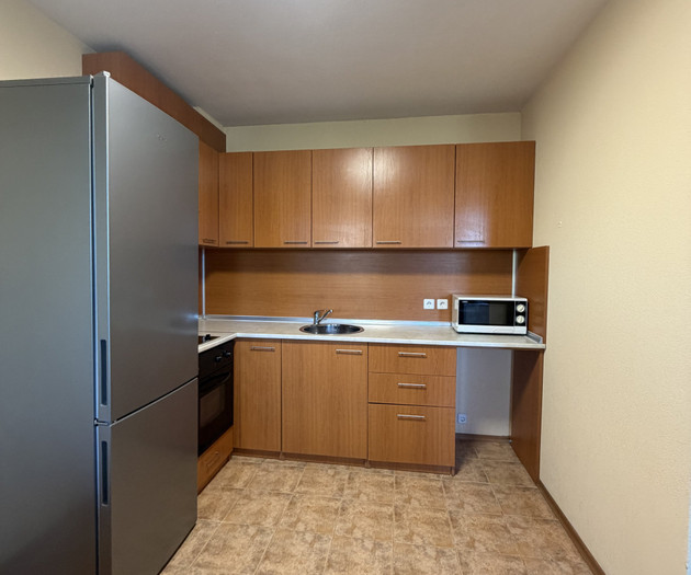 Kitchen with fridge and cabinets