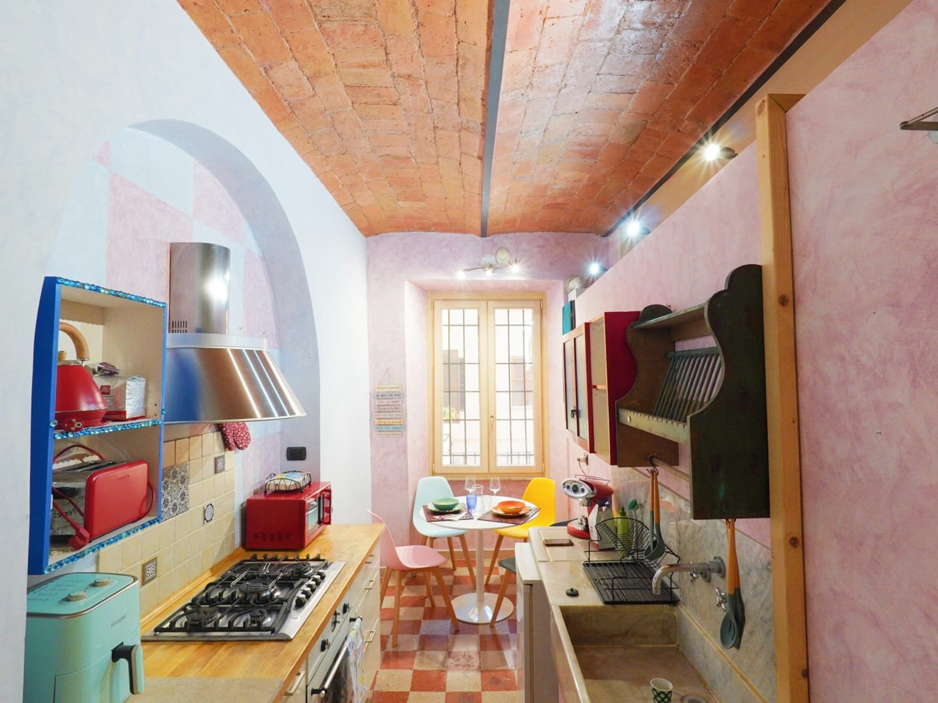 Colorful vaulted kitchen with dining nook