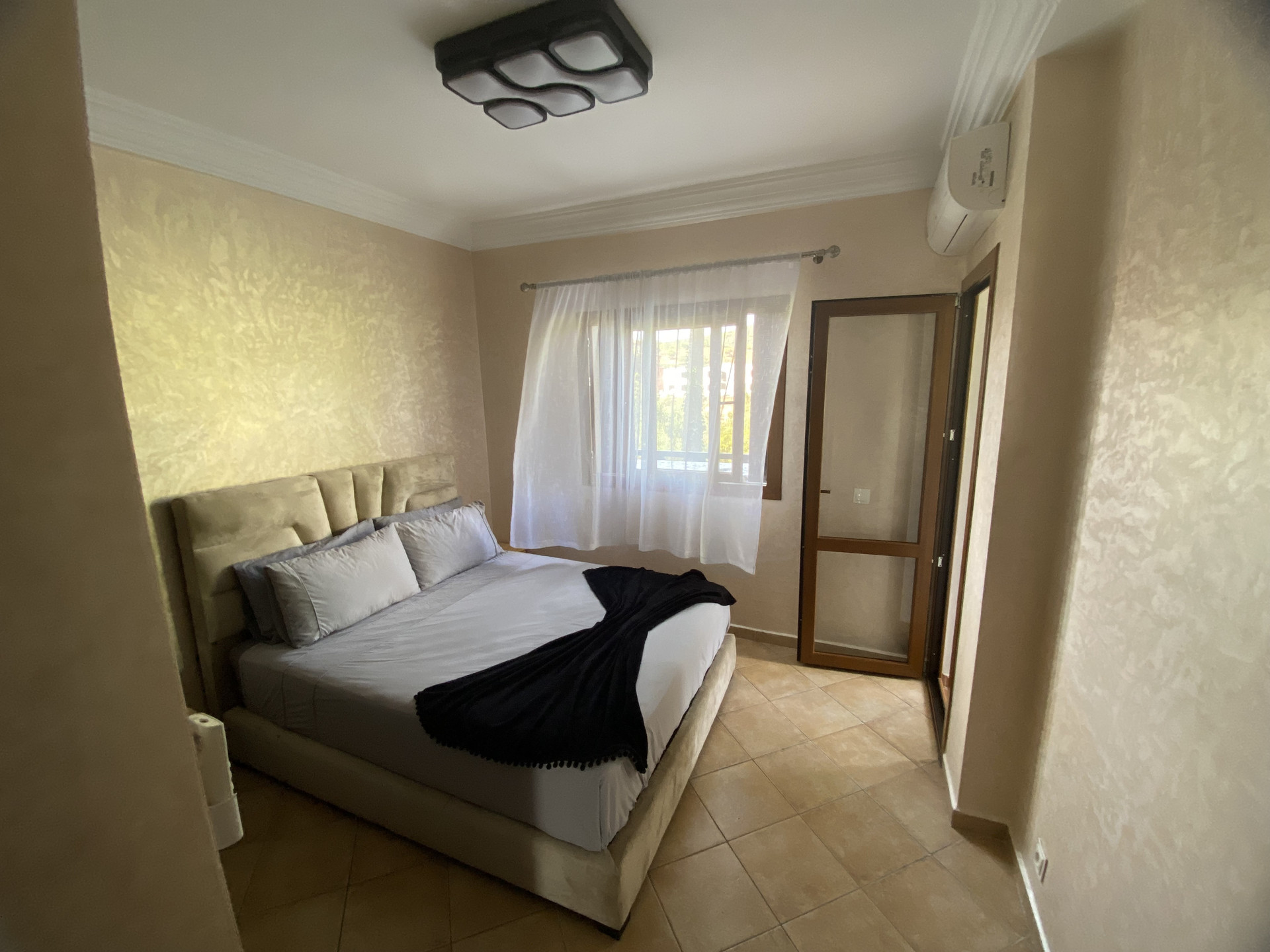 Bedroom with double bed and AC