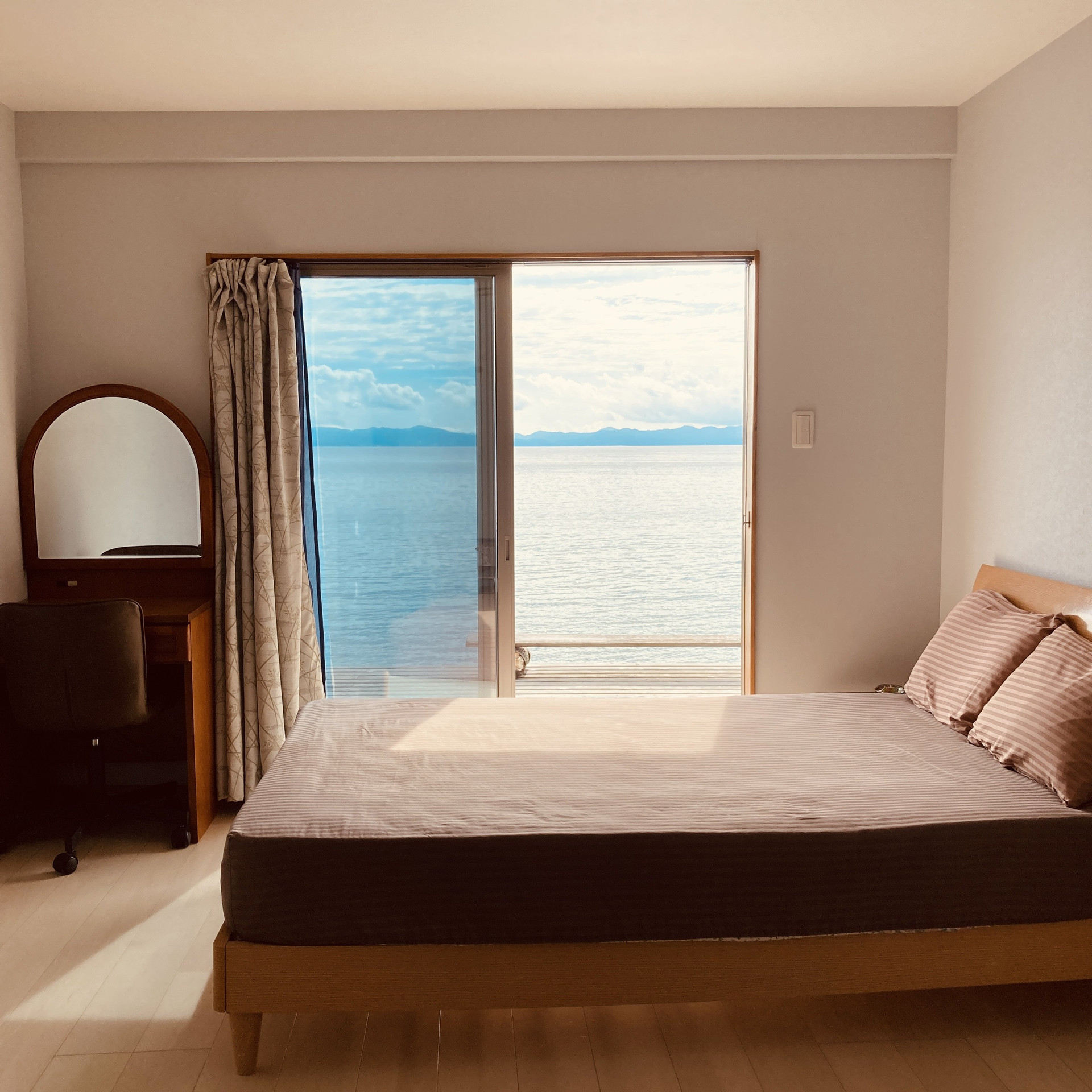 Bright bedroom with ocean view