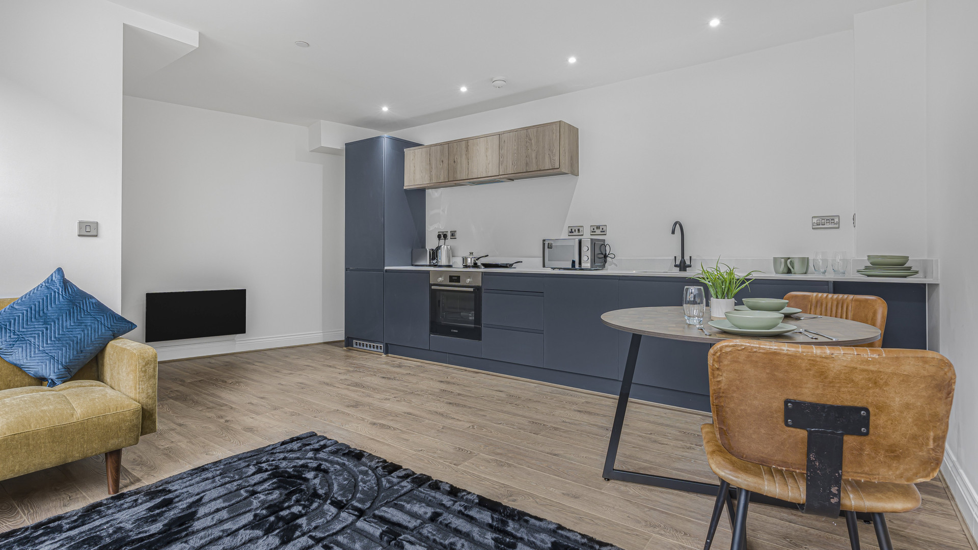 Modern blue kitchen with dining table