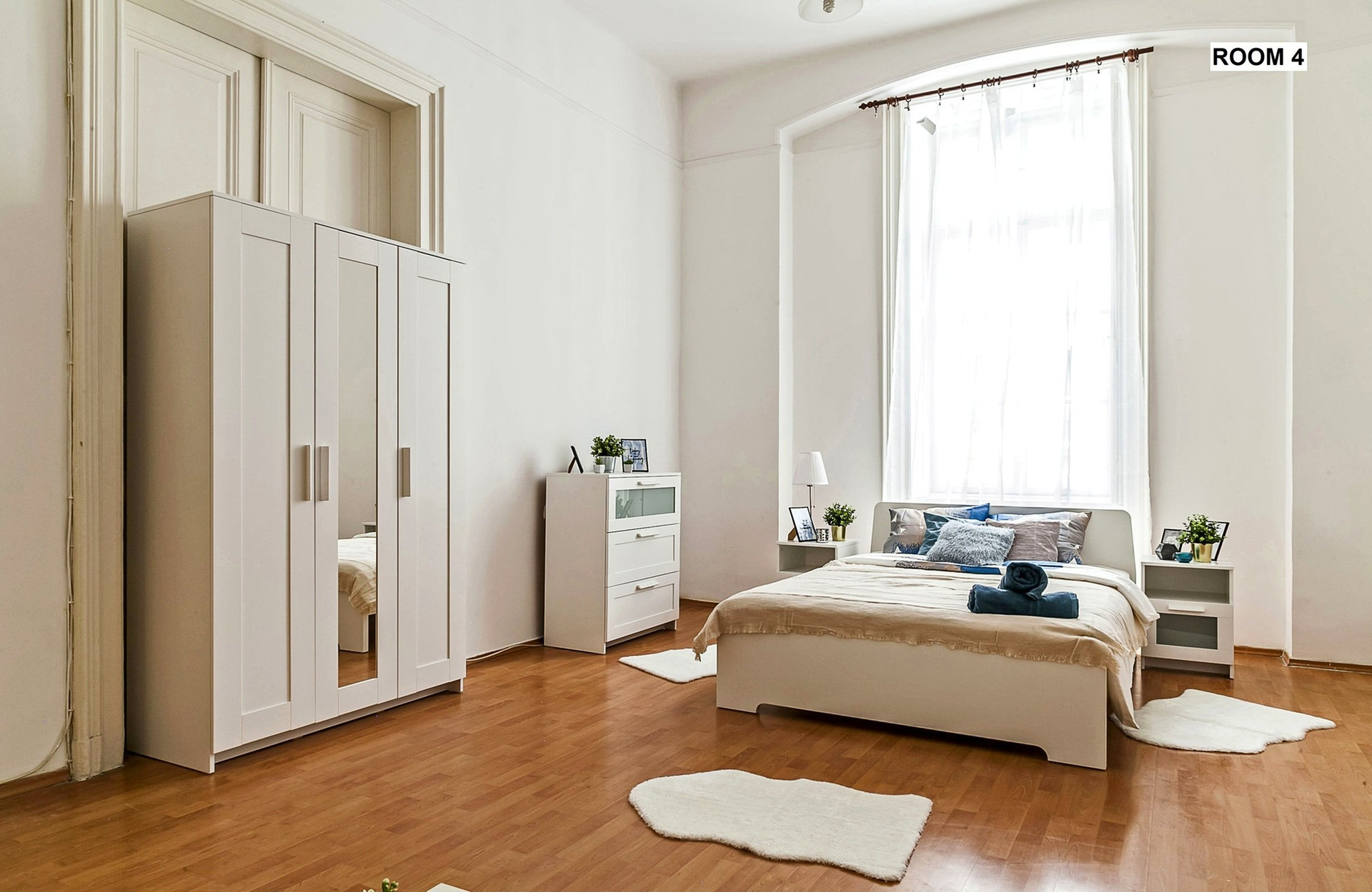 Large fully furnished room with wardrobe, high ceilings and generous living space.
