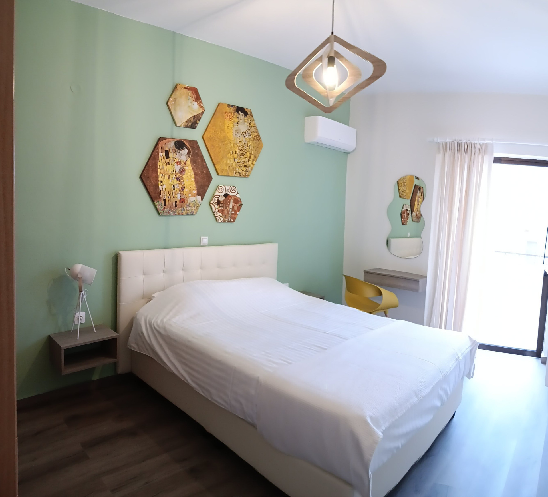 MENTA Bedroom with double bed, wardrobe and TV