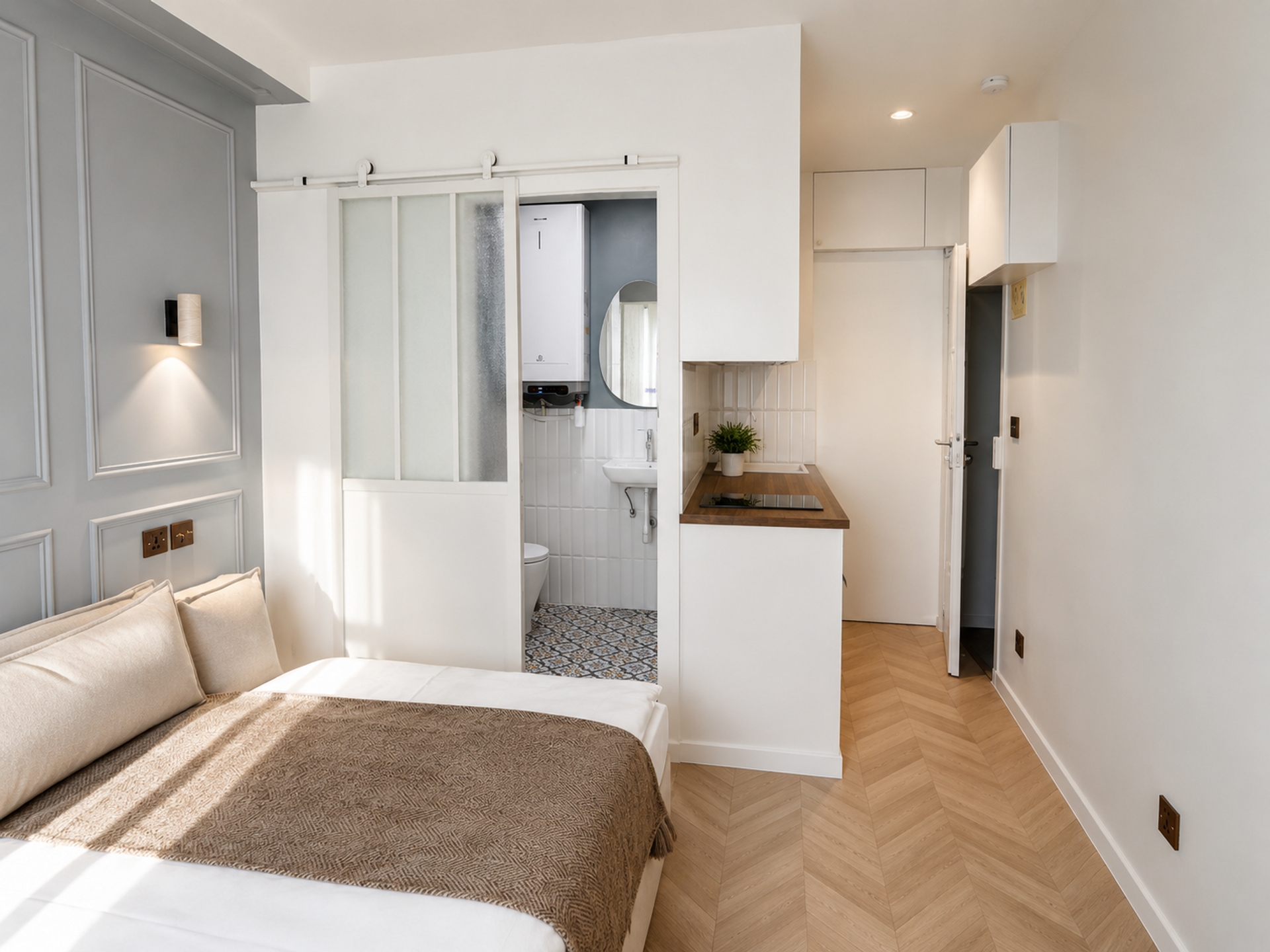 Studio overview with bed and kitchen