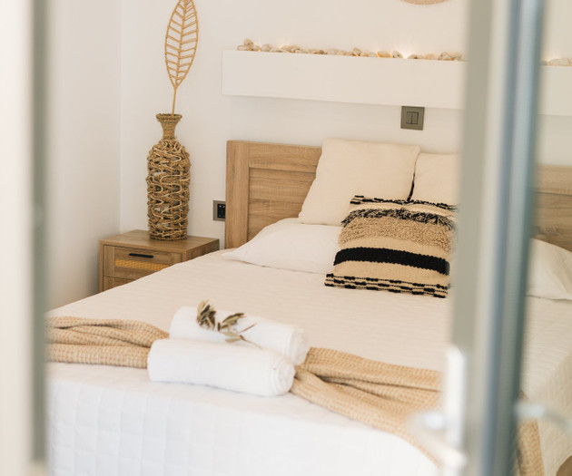 Bed with towels, door view