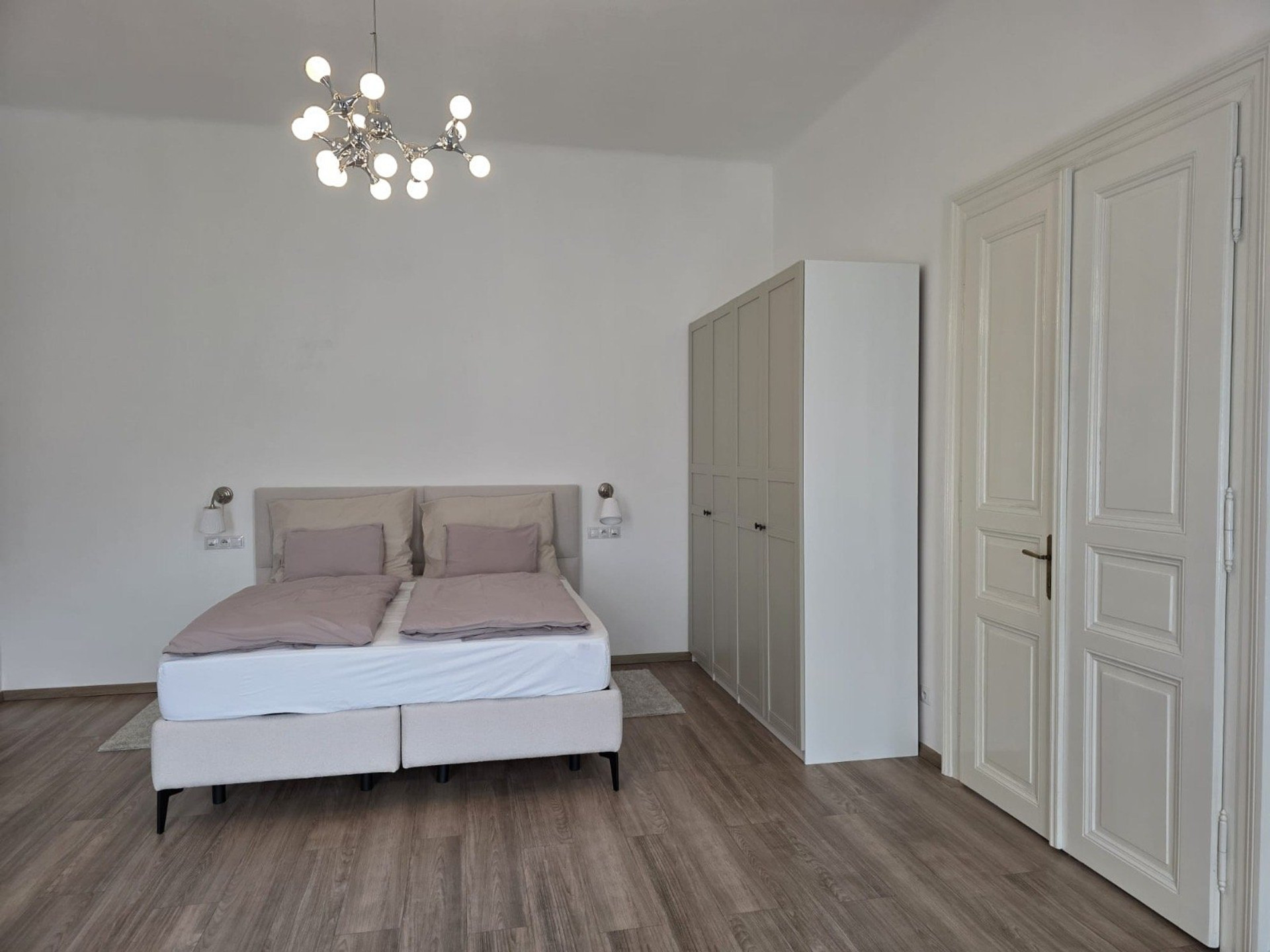 Bright bedroom with double bed wardrobe