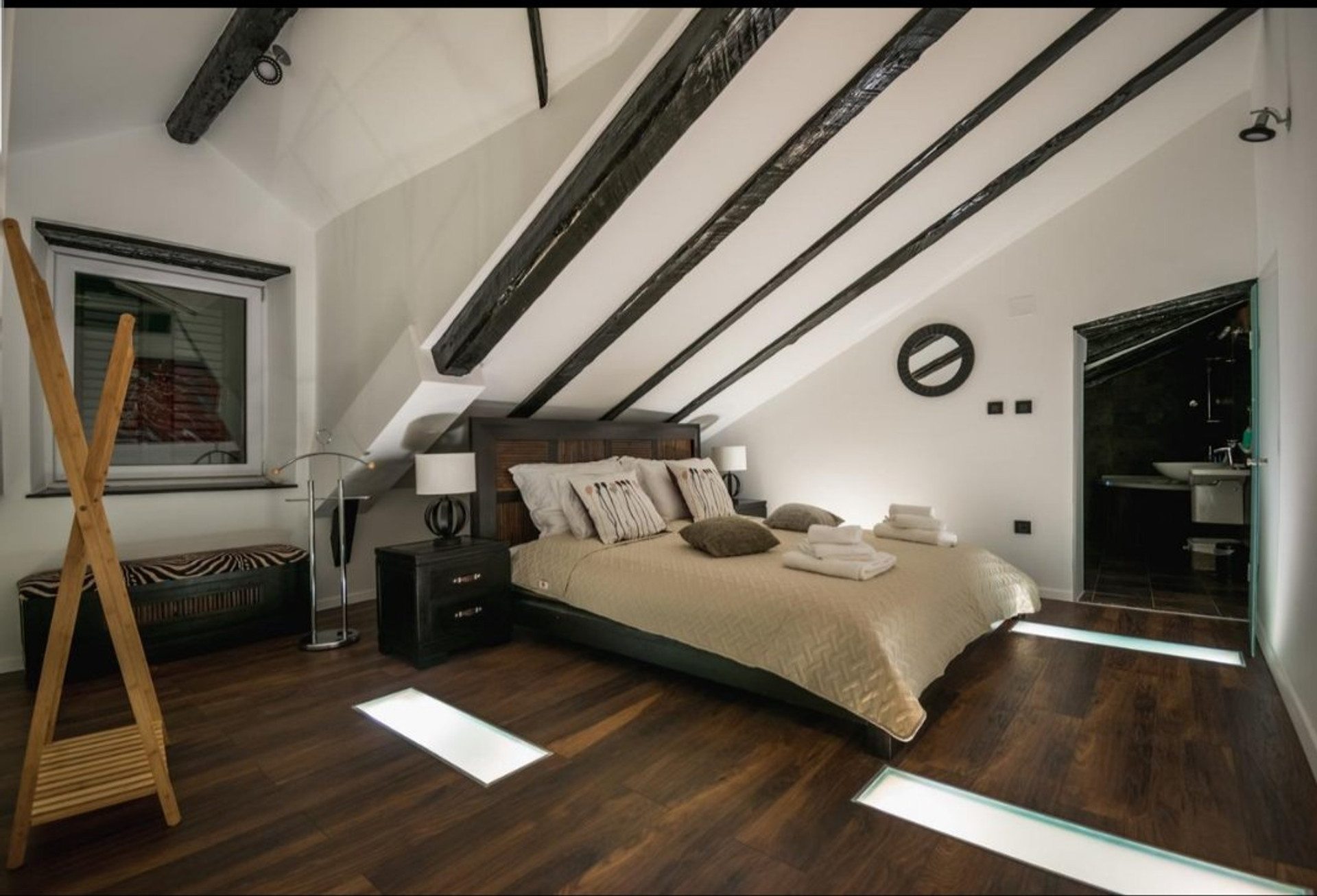 Spacious attic bedroom with beams