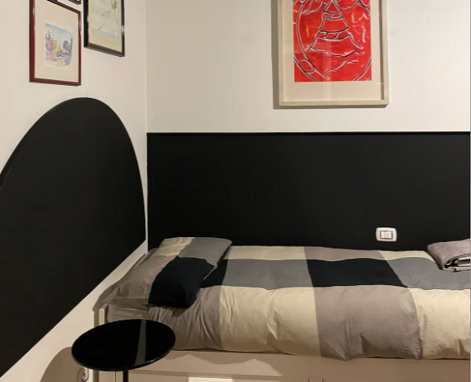 Bedroom with black headboard artwork