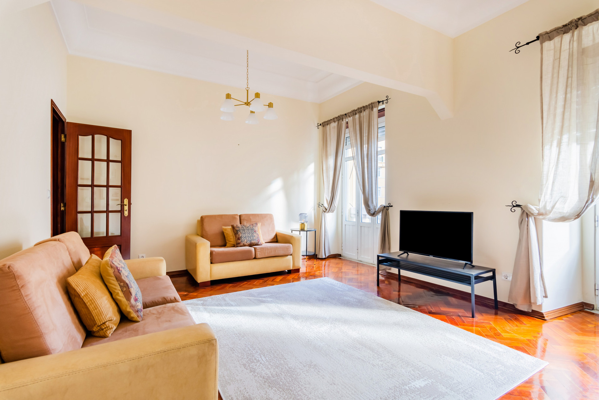 Living Room with Flat-Screen TV and Balcony
