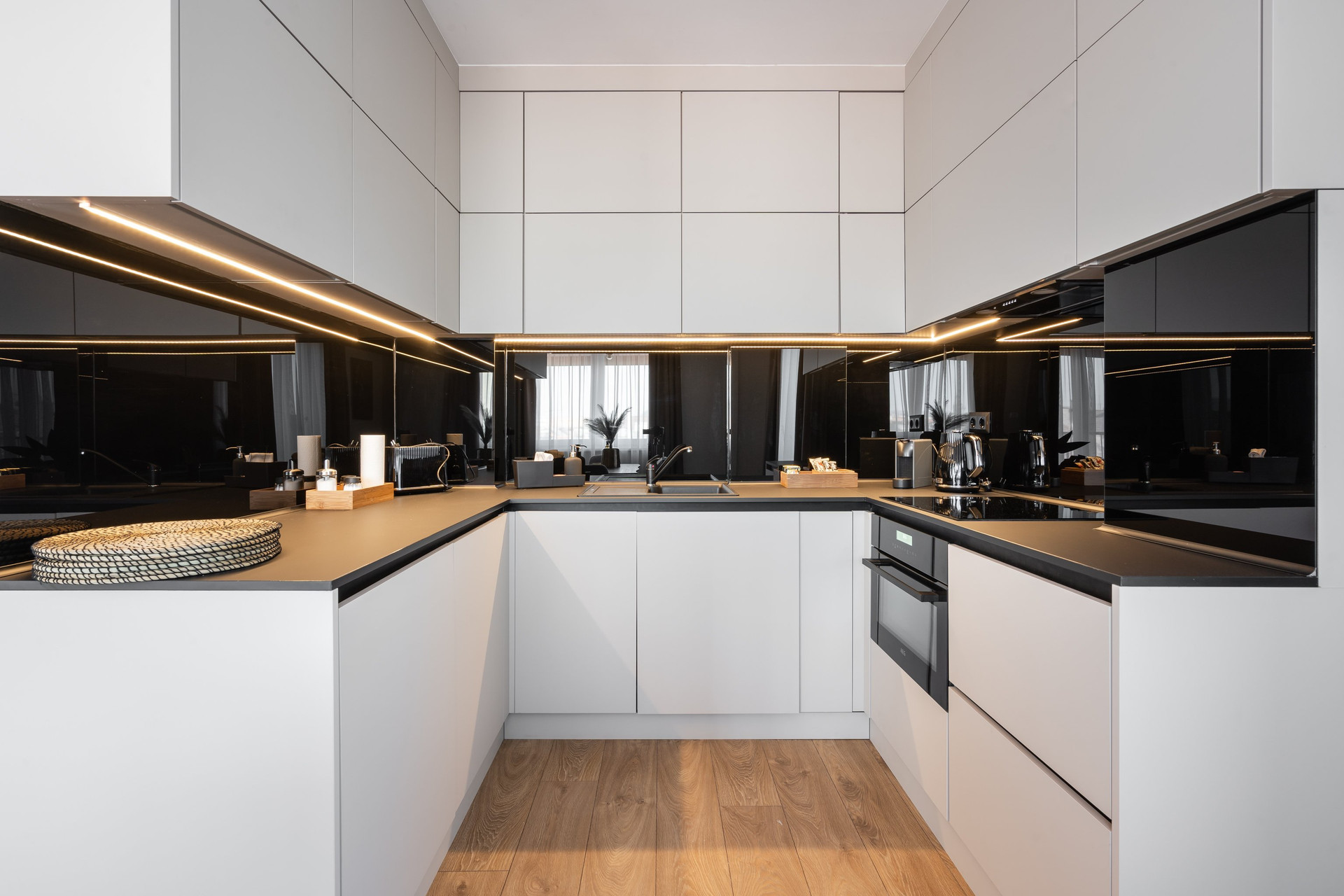 Sleek U-shaped white kitchen