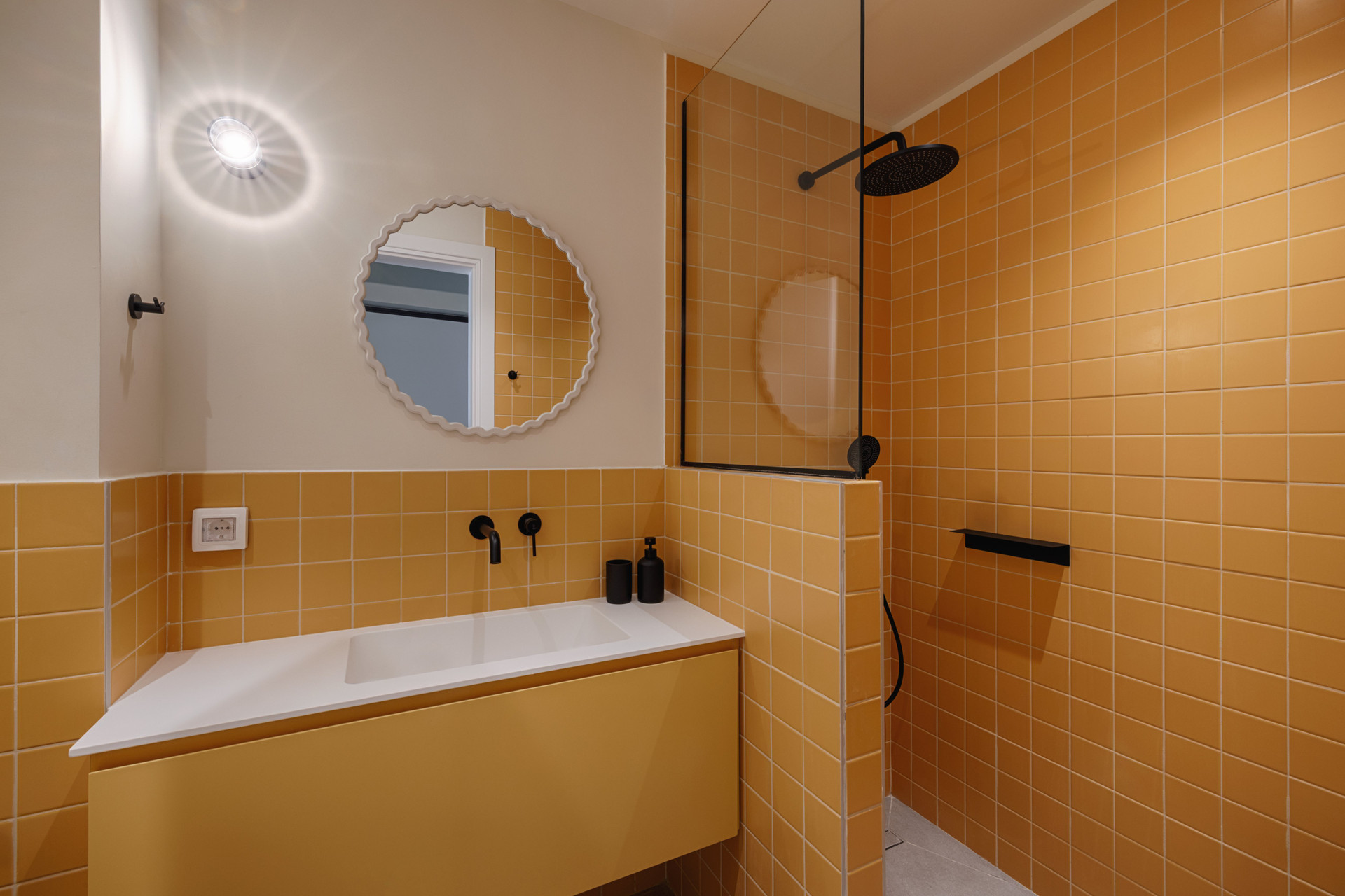 Yellow tiled bathroom with rain shower