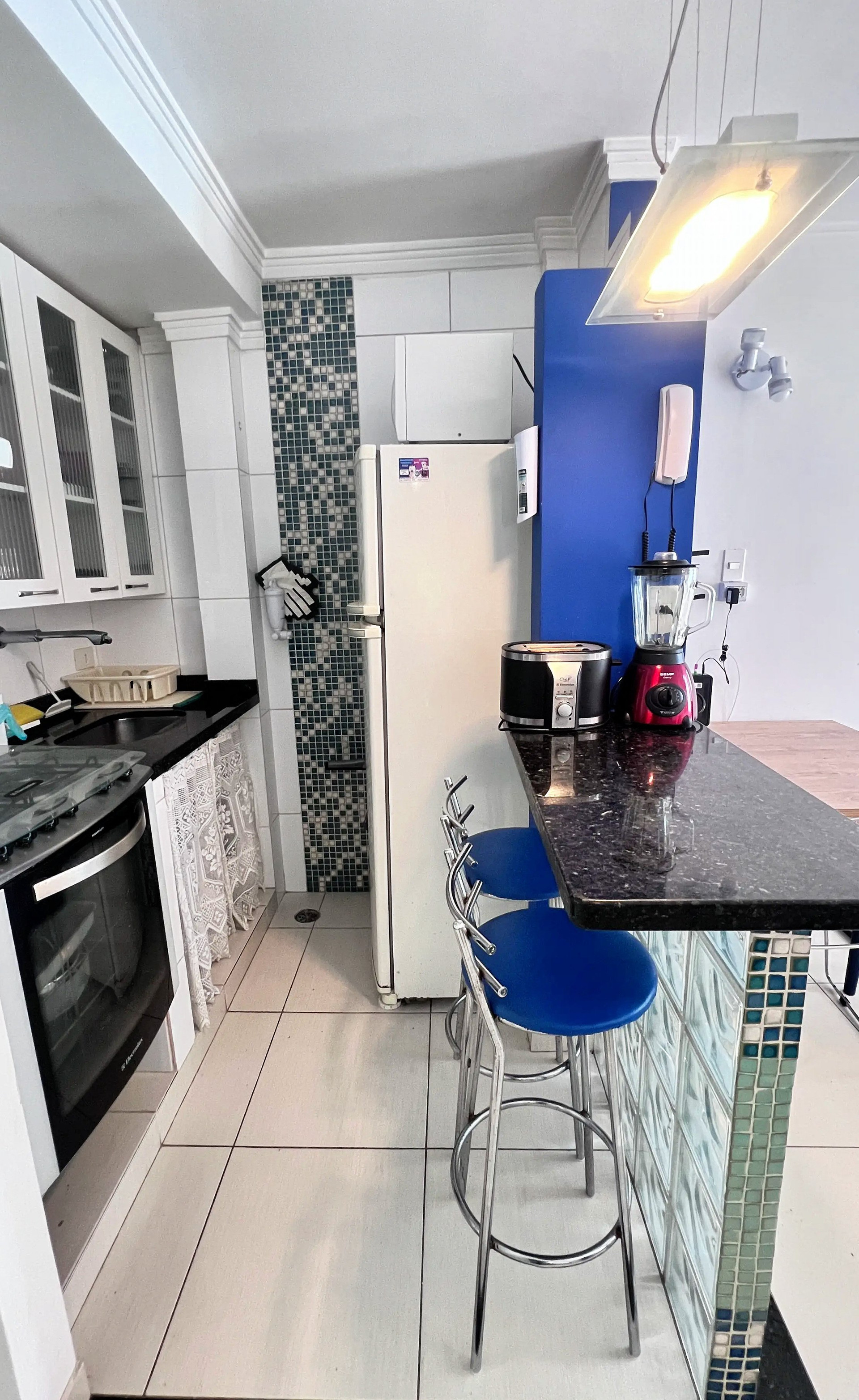 Kitchen with bar stools and oven