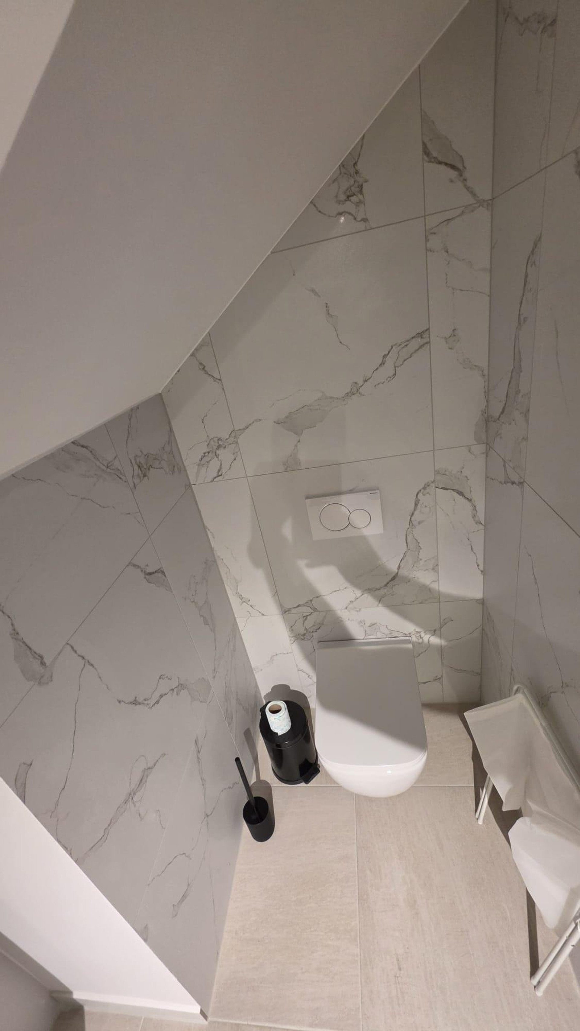 Marble toilet with sloped ceiling