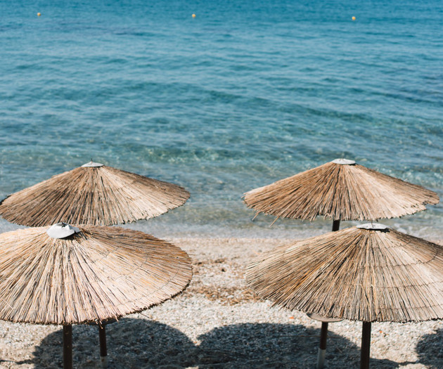 Straw umbrellas on beach