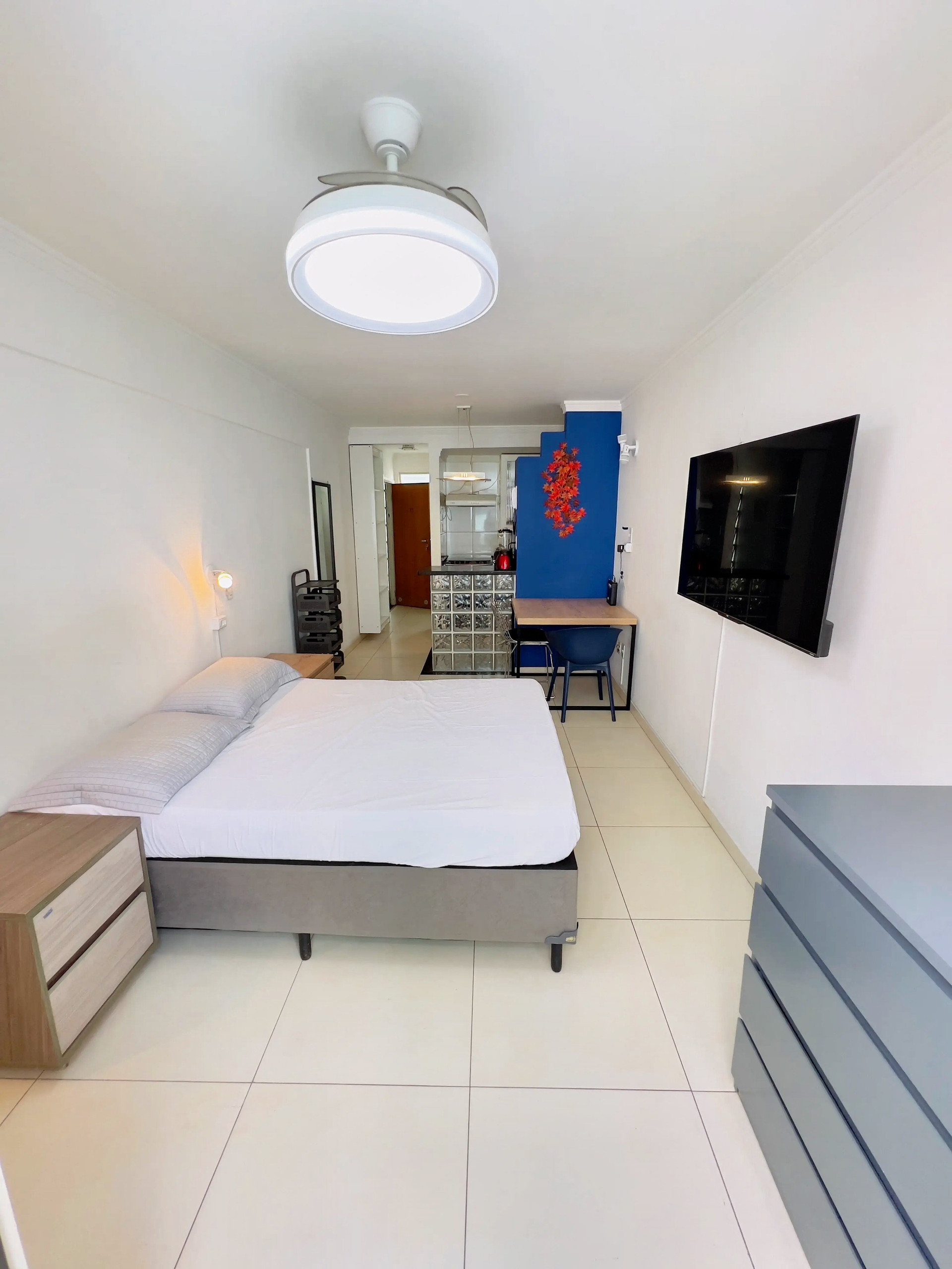 Studio bedroom with blue accent wall