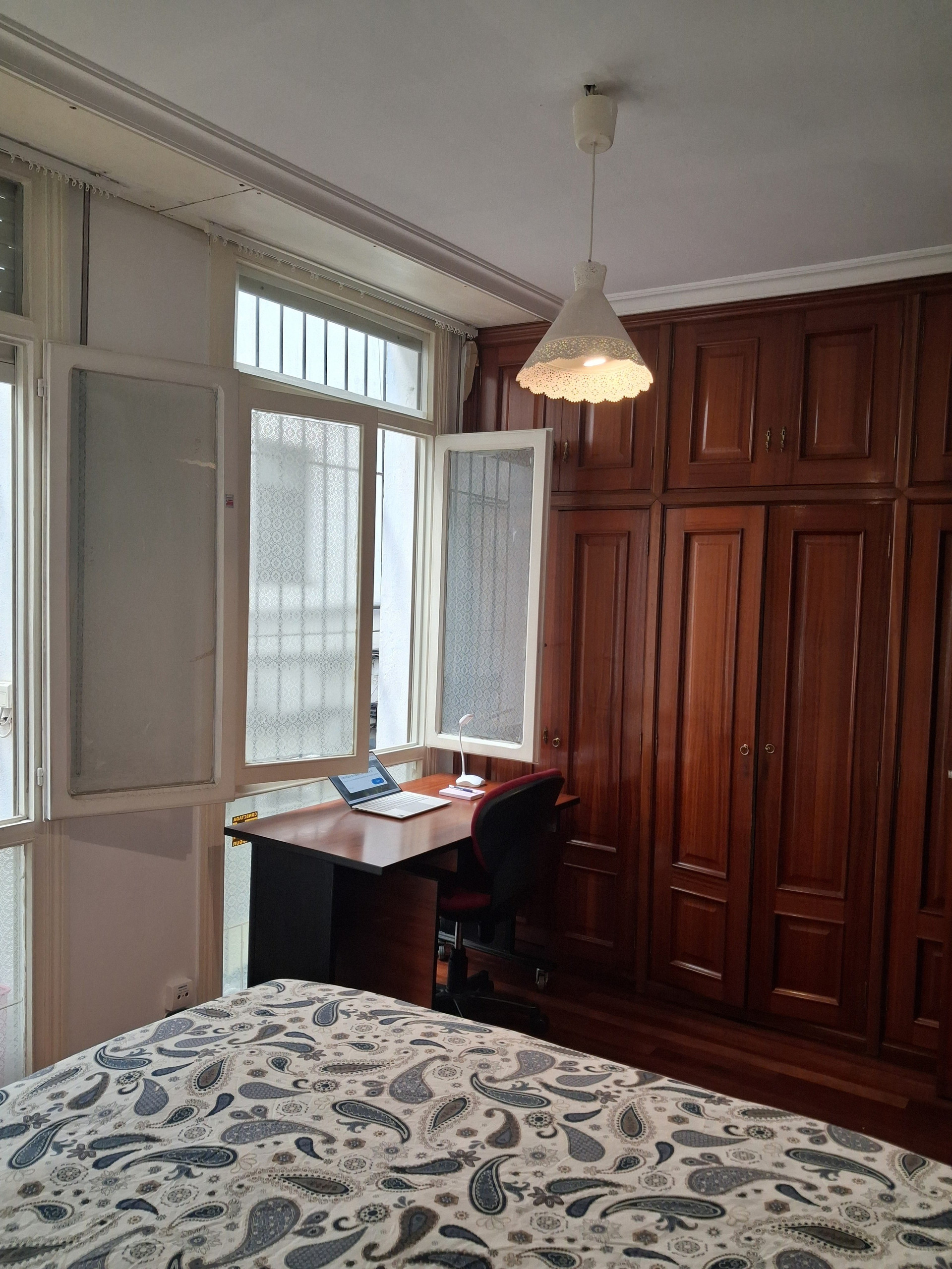 Desk by window and wardrobes