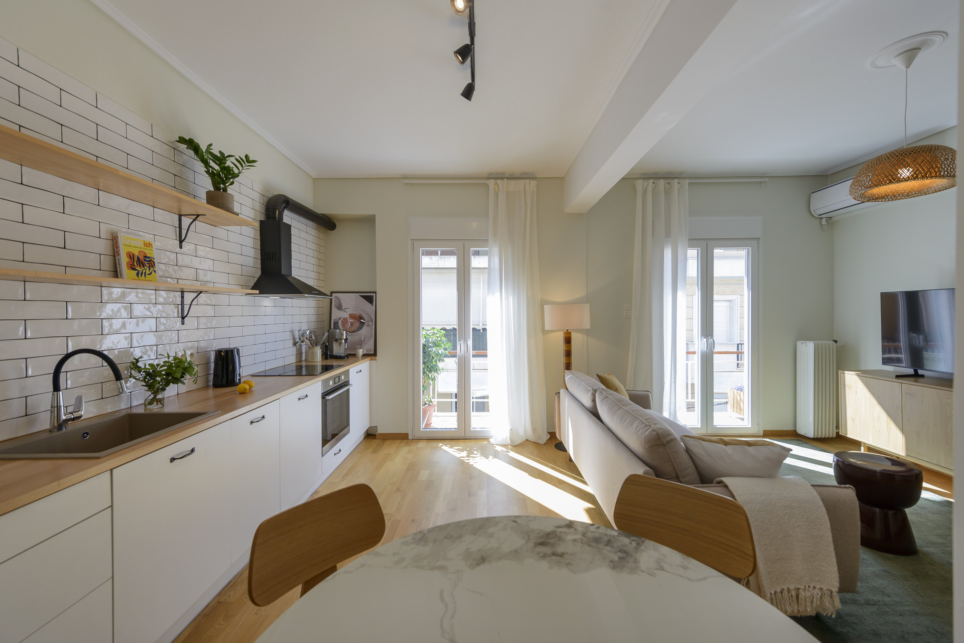 Open living space with dining area and two balcony doors