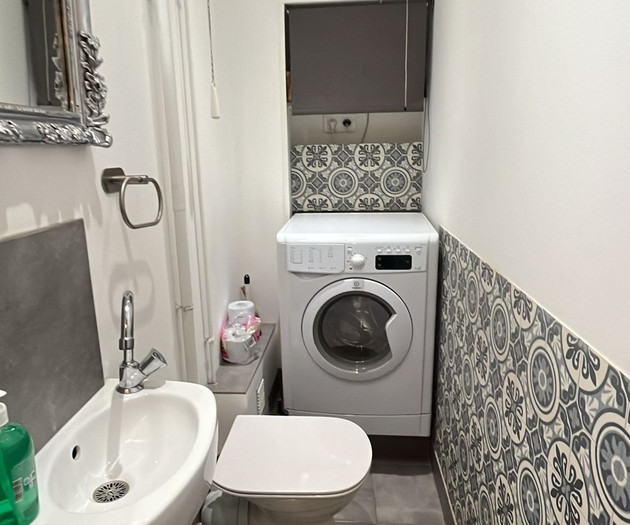 Bathroom with washer and toilet