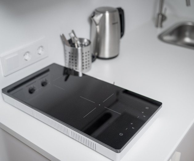 Kitchen countertop with stove and kettle