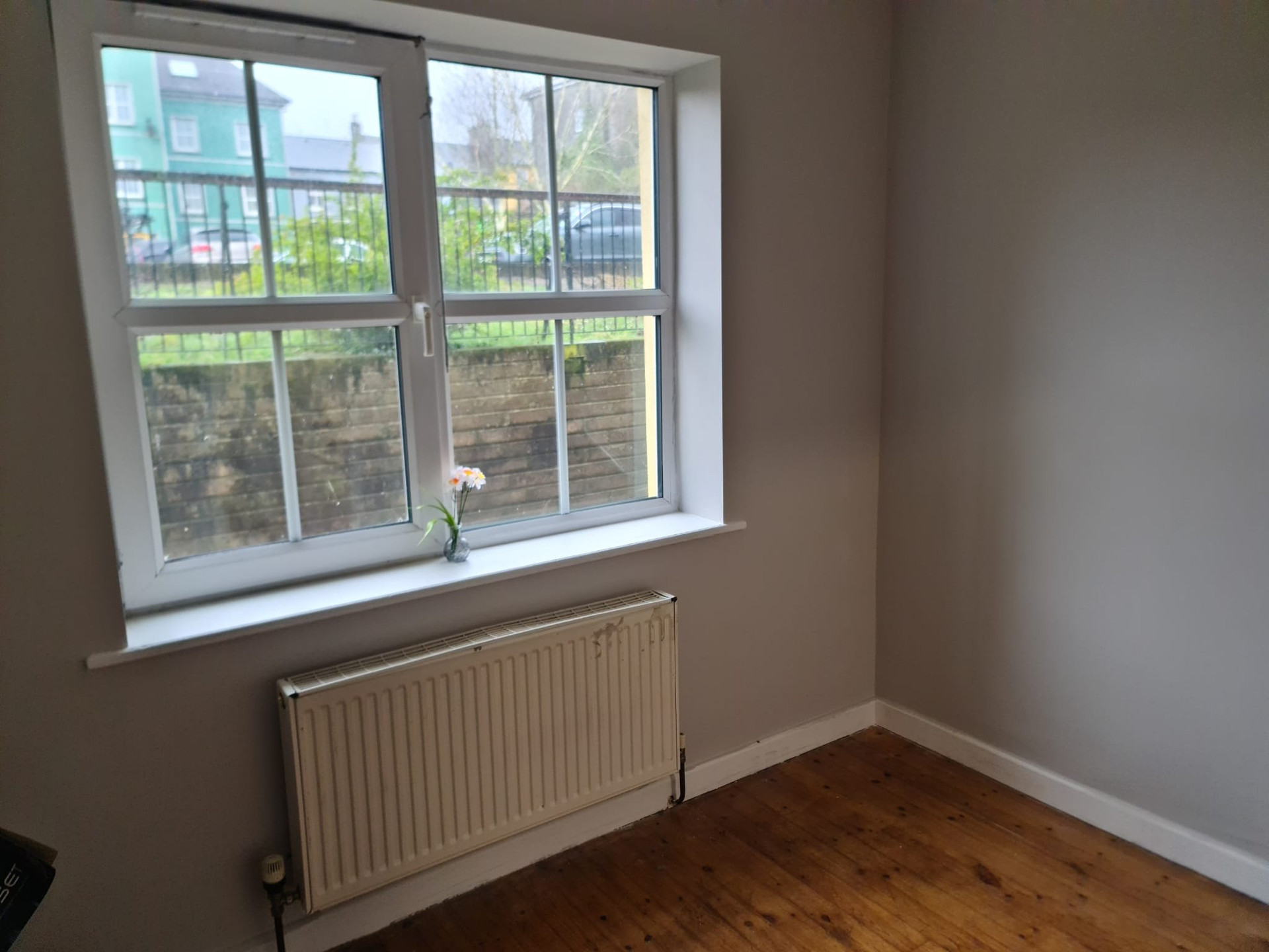 Empty bedroom with window and radiator