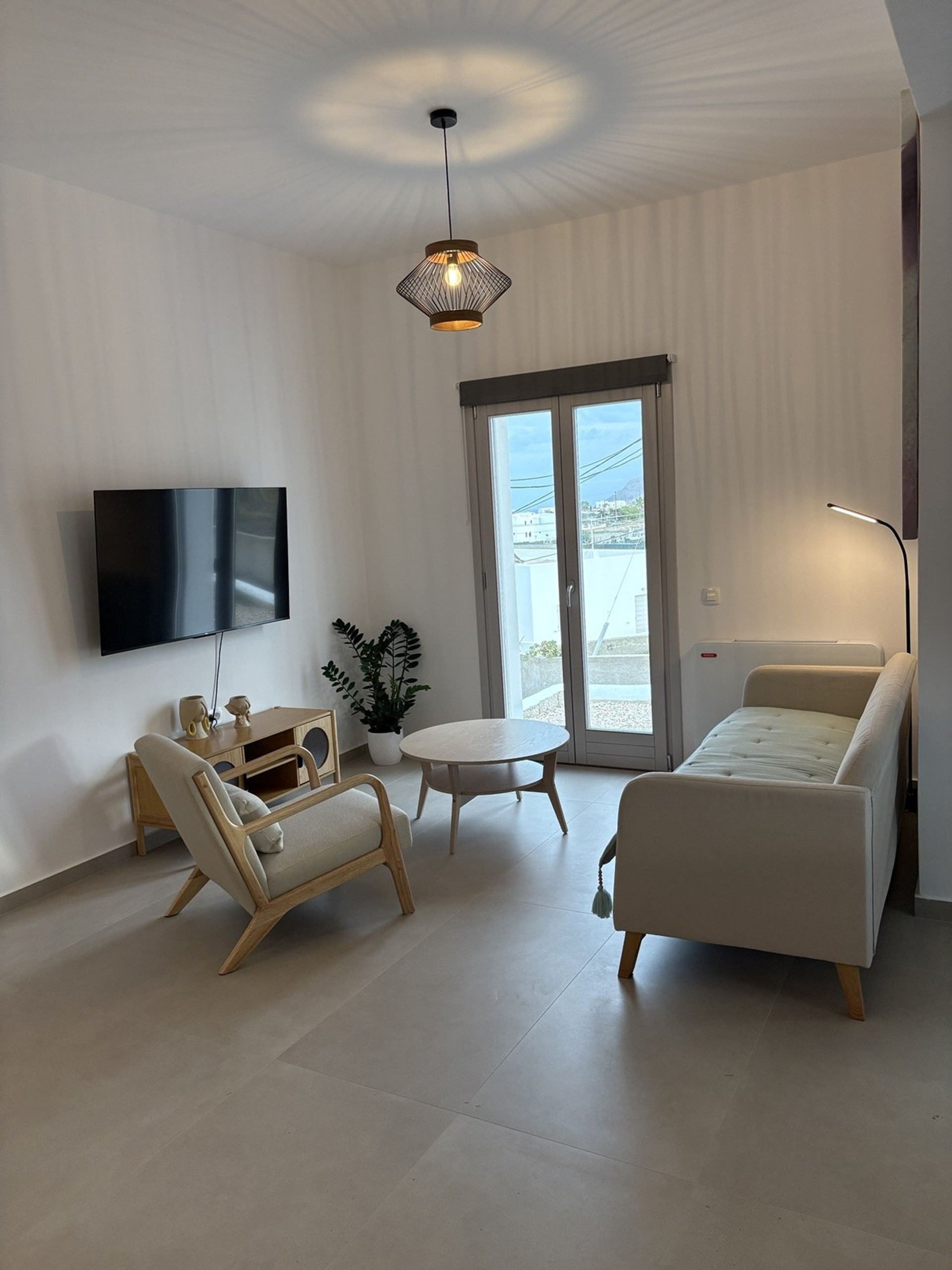 Bright living room with sofa and TV