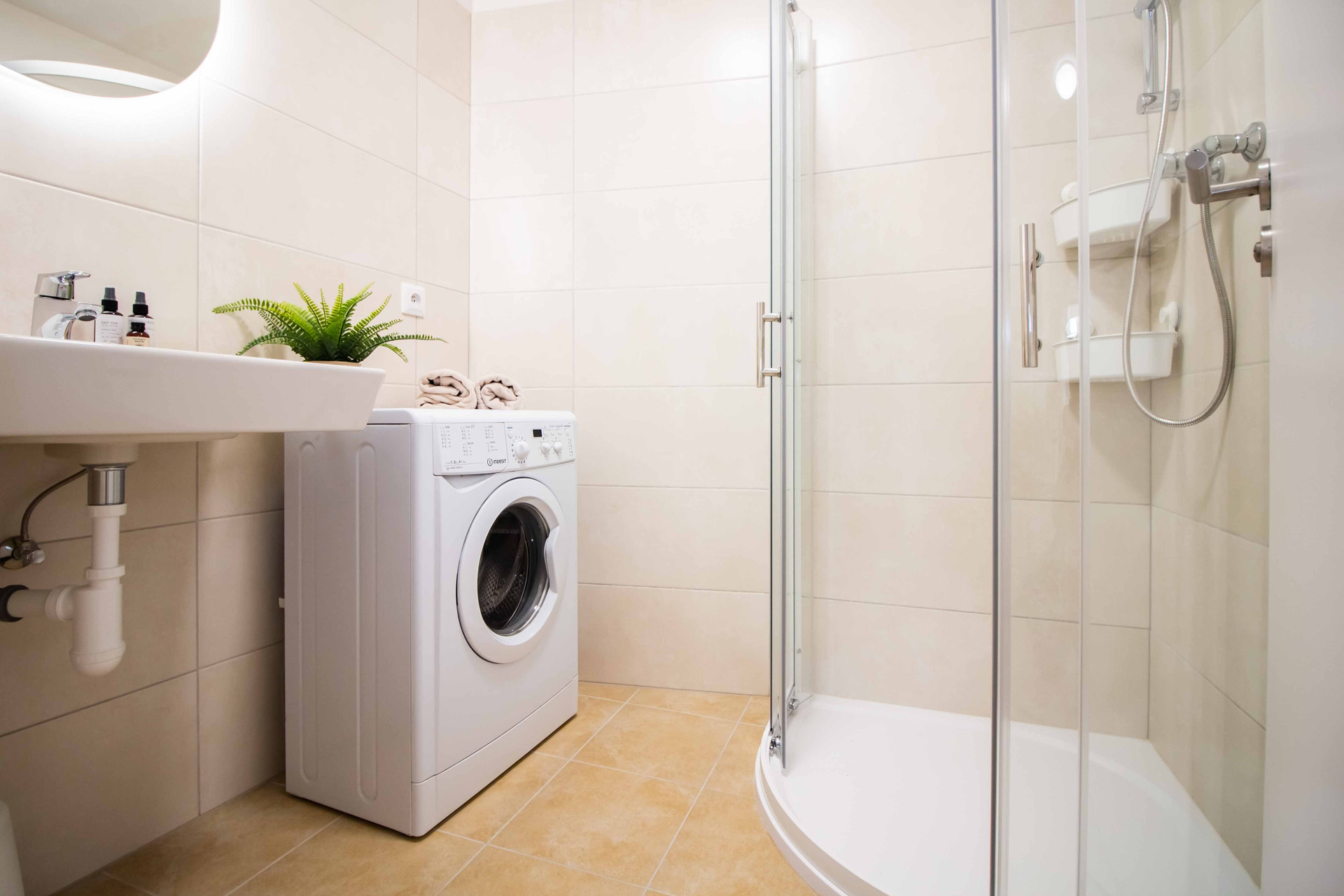 Bathroom with shower and washing machine