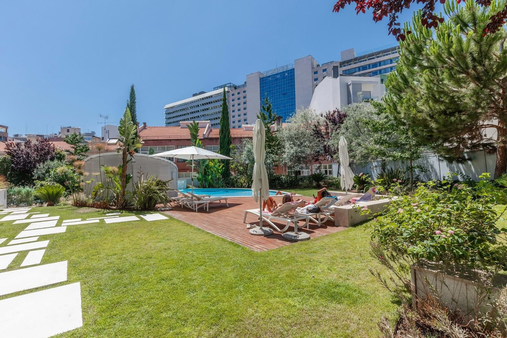 Pool deck with sun loungers garden