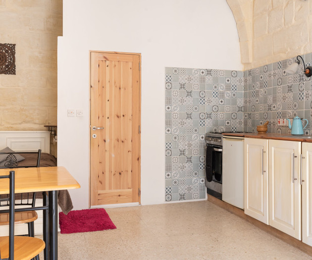 Kitchen with stone walls and door