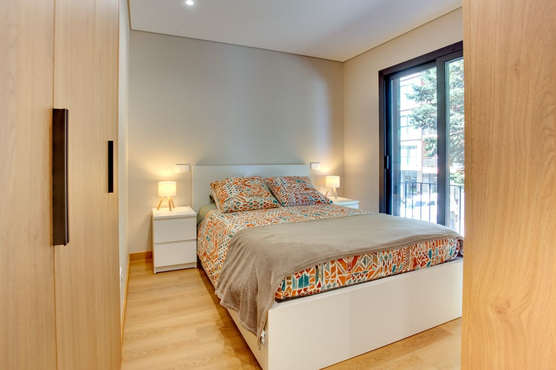 Bedroom with double bed and balcony