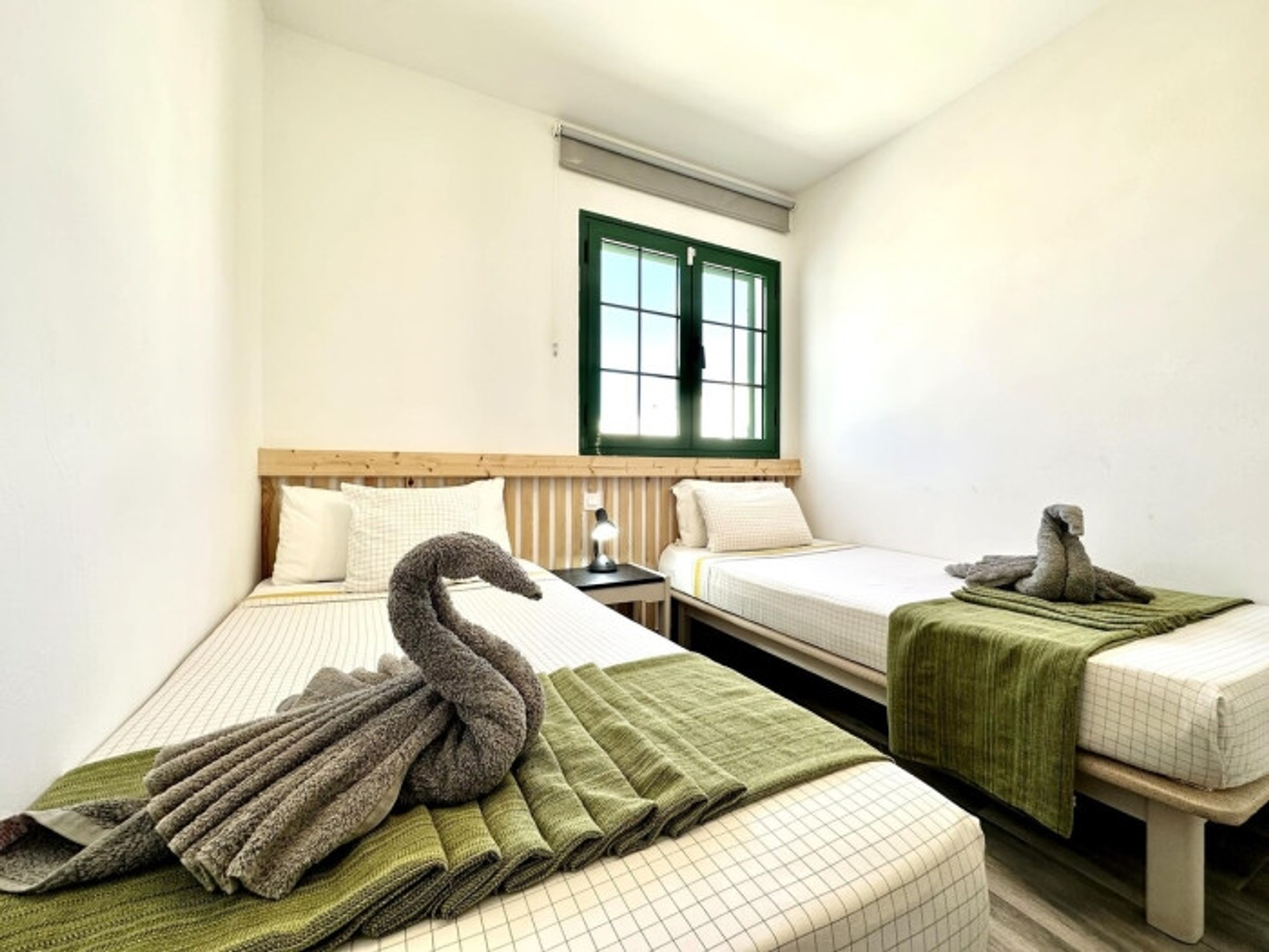 Twin bedroom with towel swans
