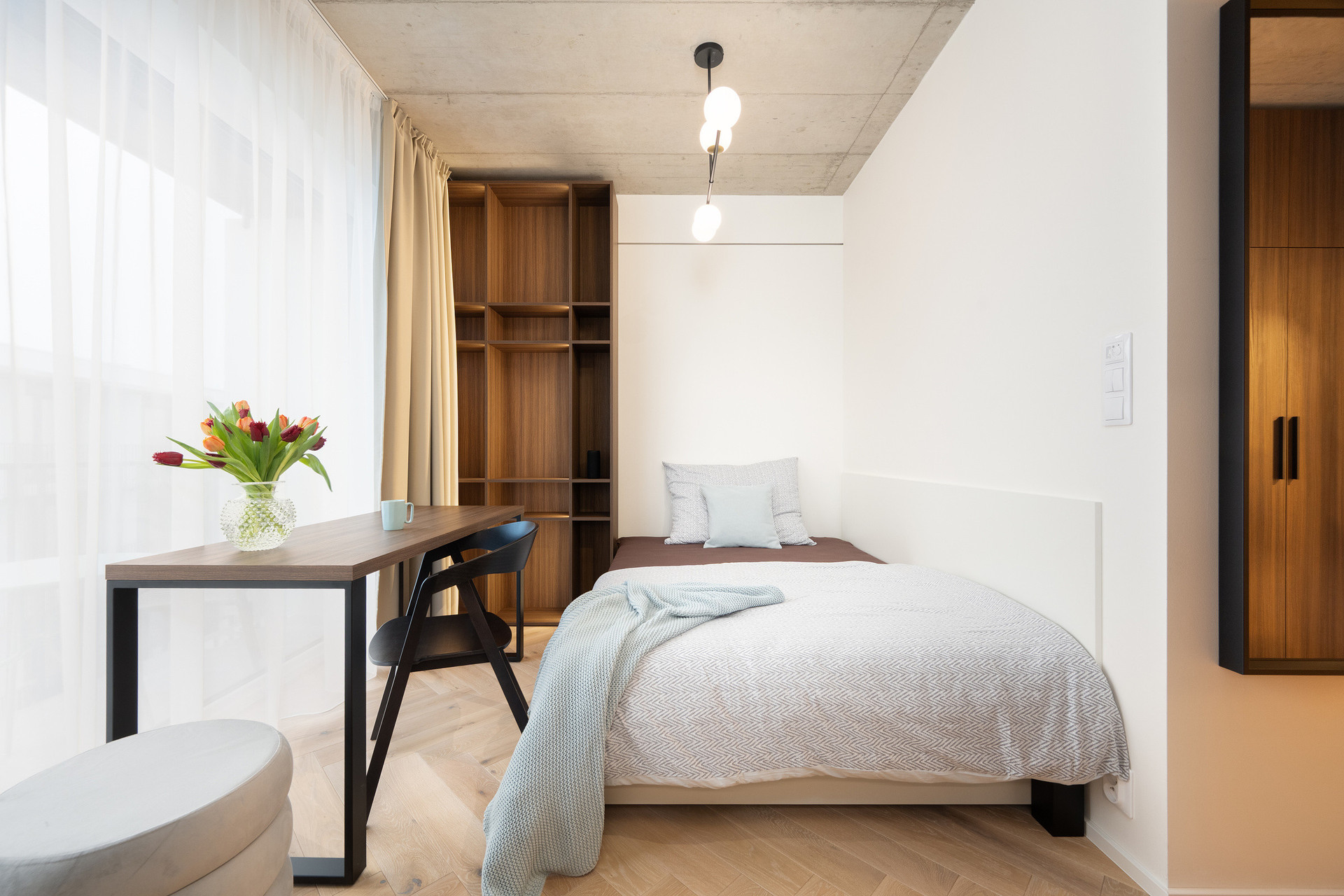 Bedroom with desk and wooden shelves