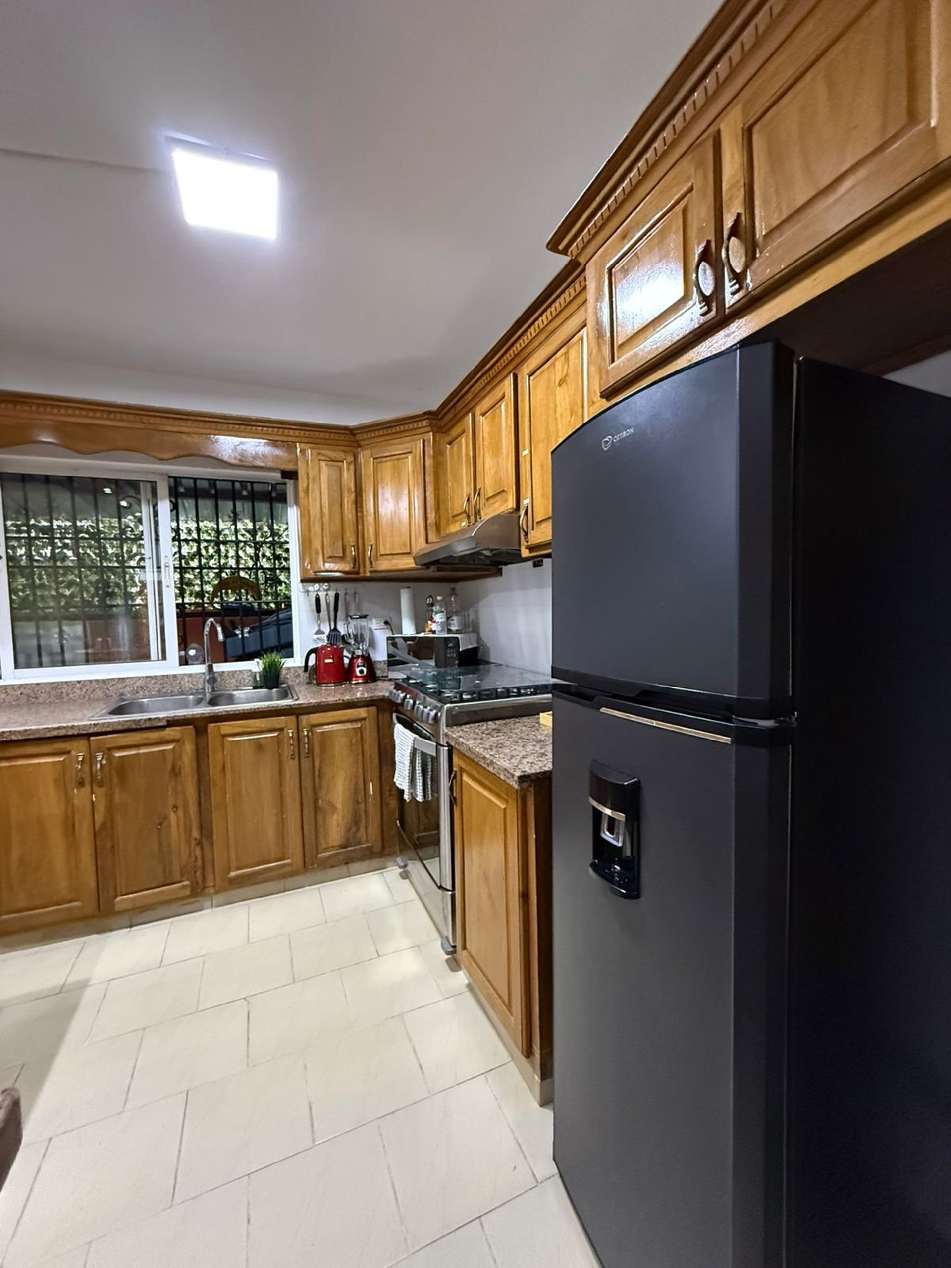 Full kitchen view with refrigerator
