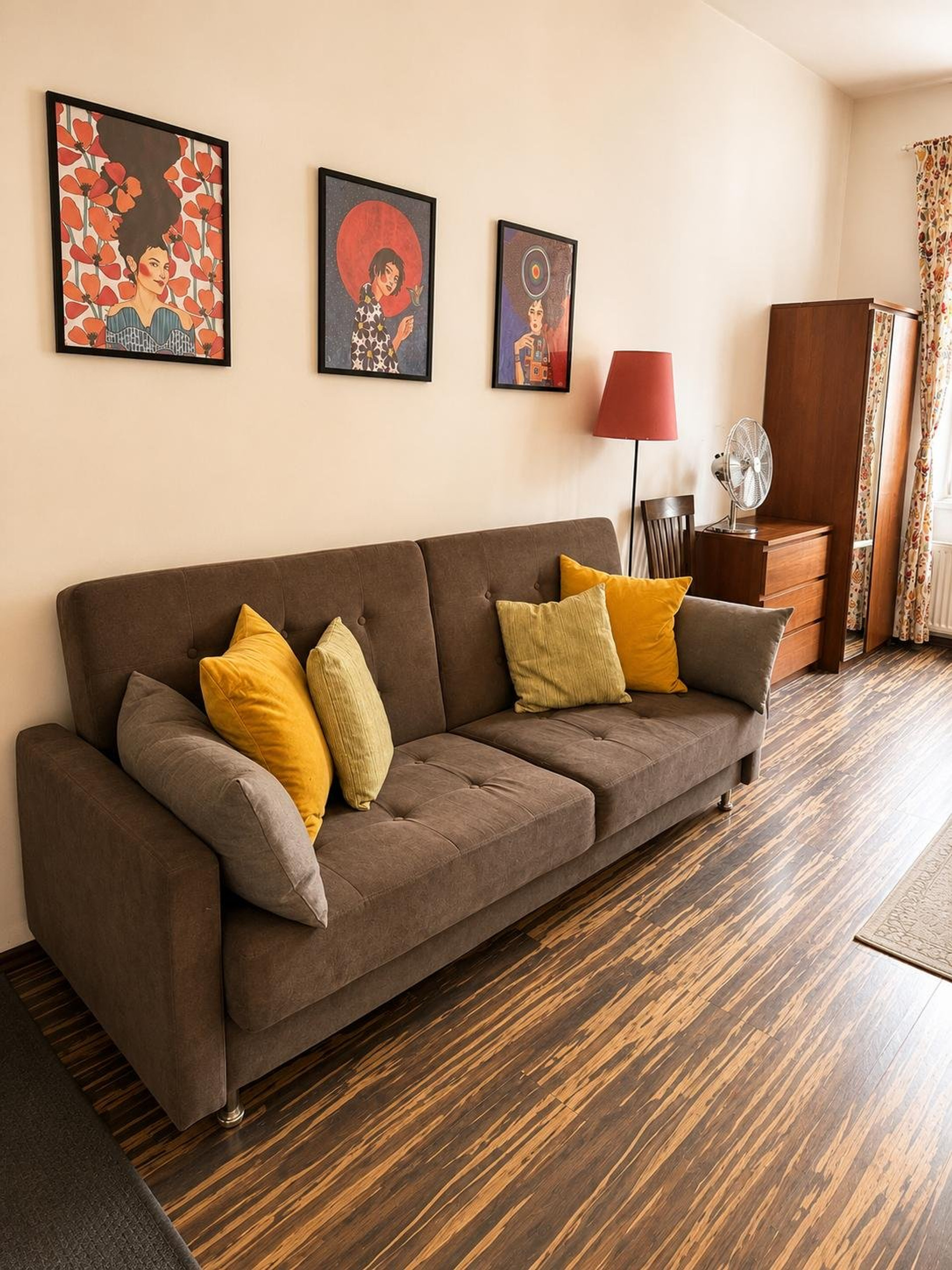Cozy sofa with colorful art prints