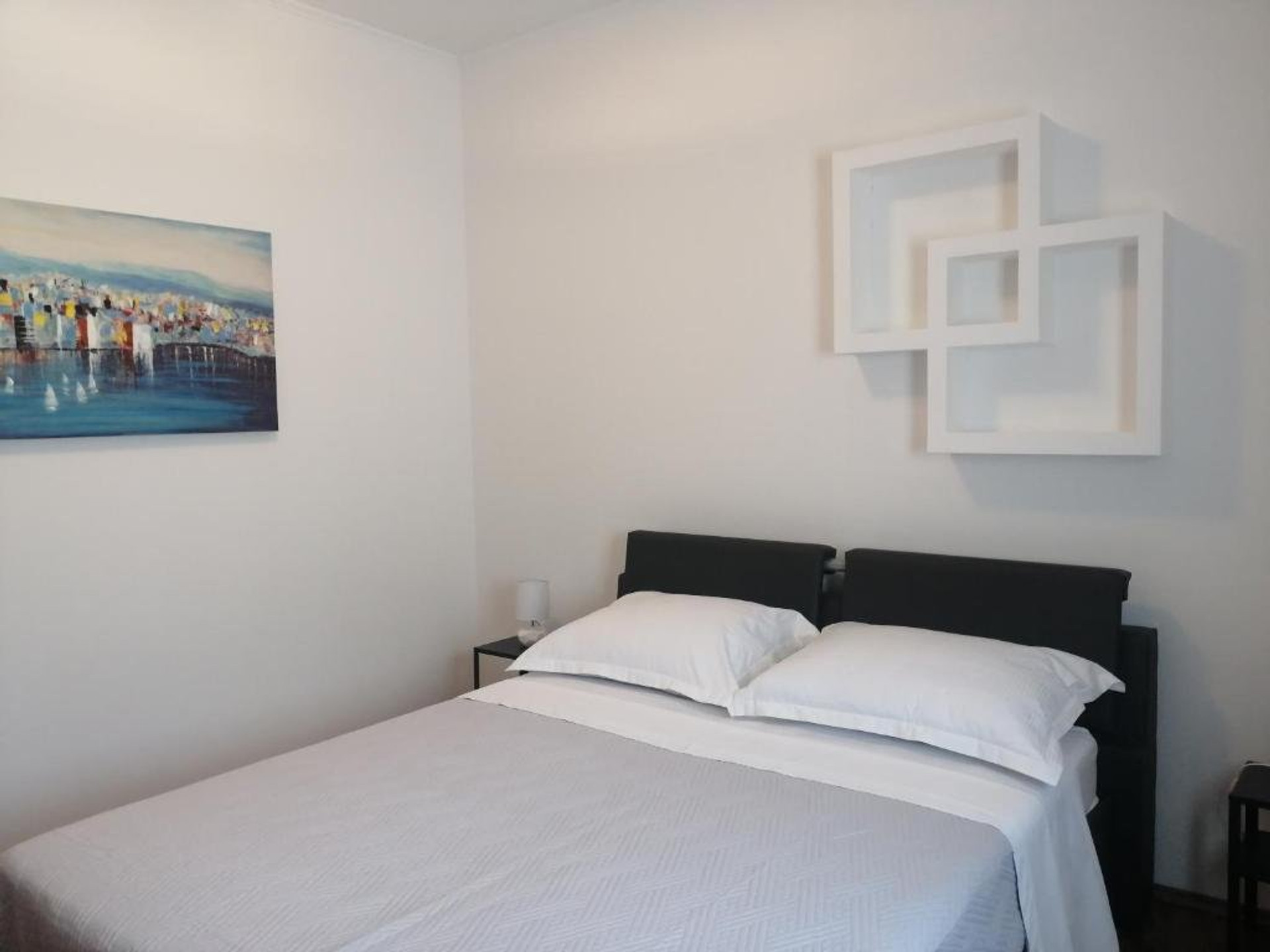 Clean white bedroom with double bed