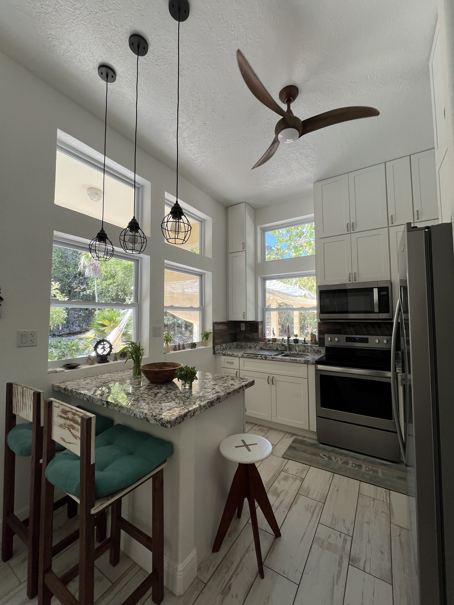 Modern white kitchen with stainless appliances