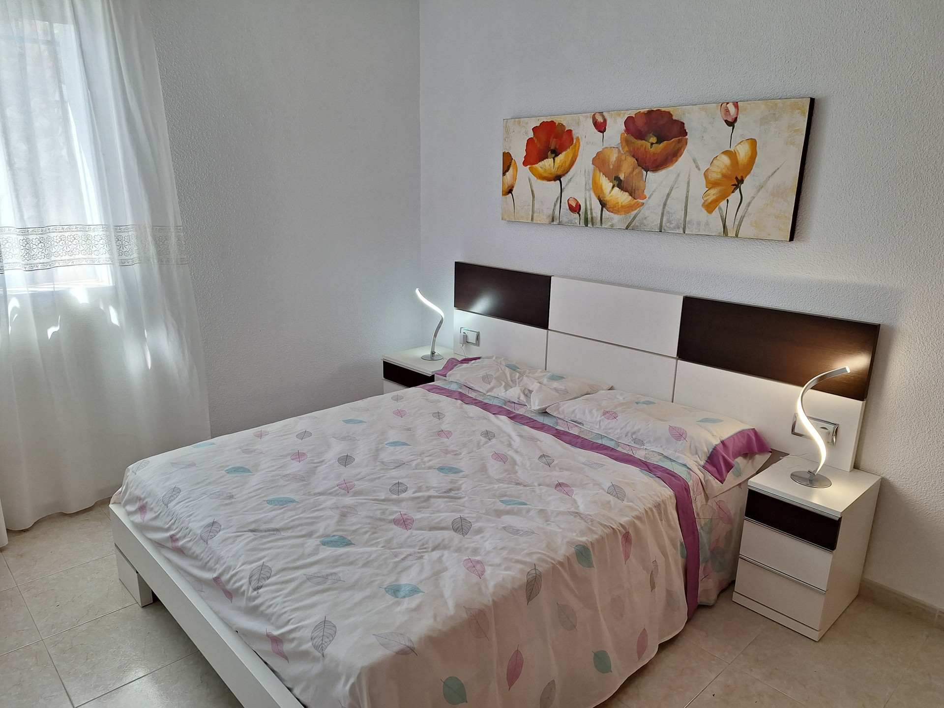 Bedroom with floral wall art