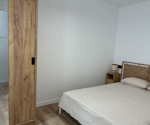 Bedroom with rattan headboard