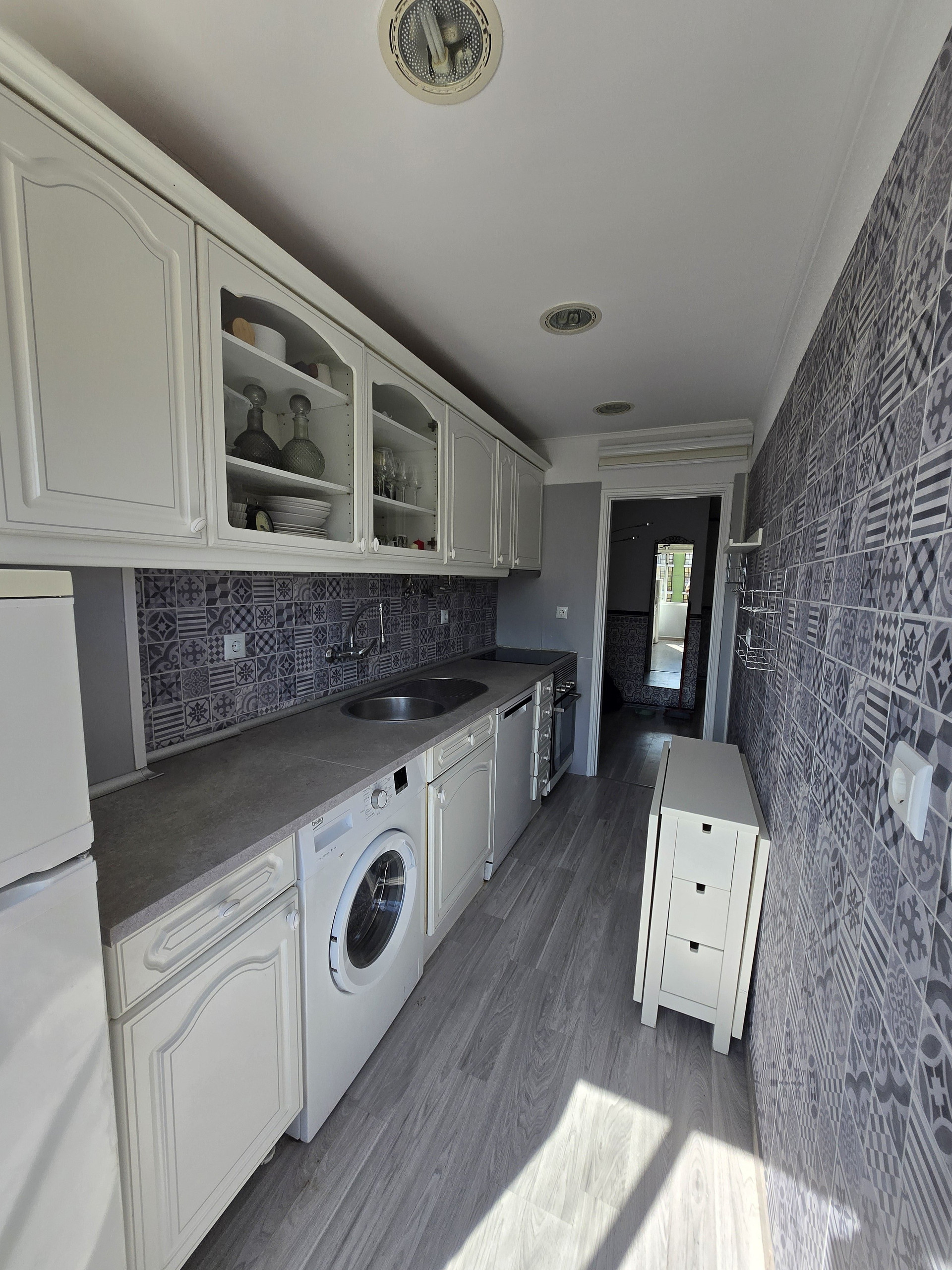 Kitchen with laundry appliances view