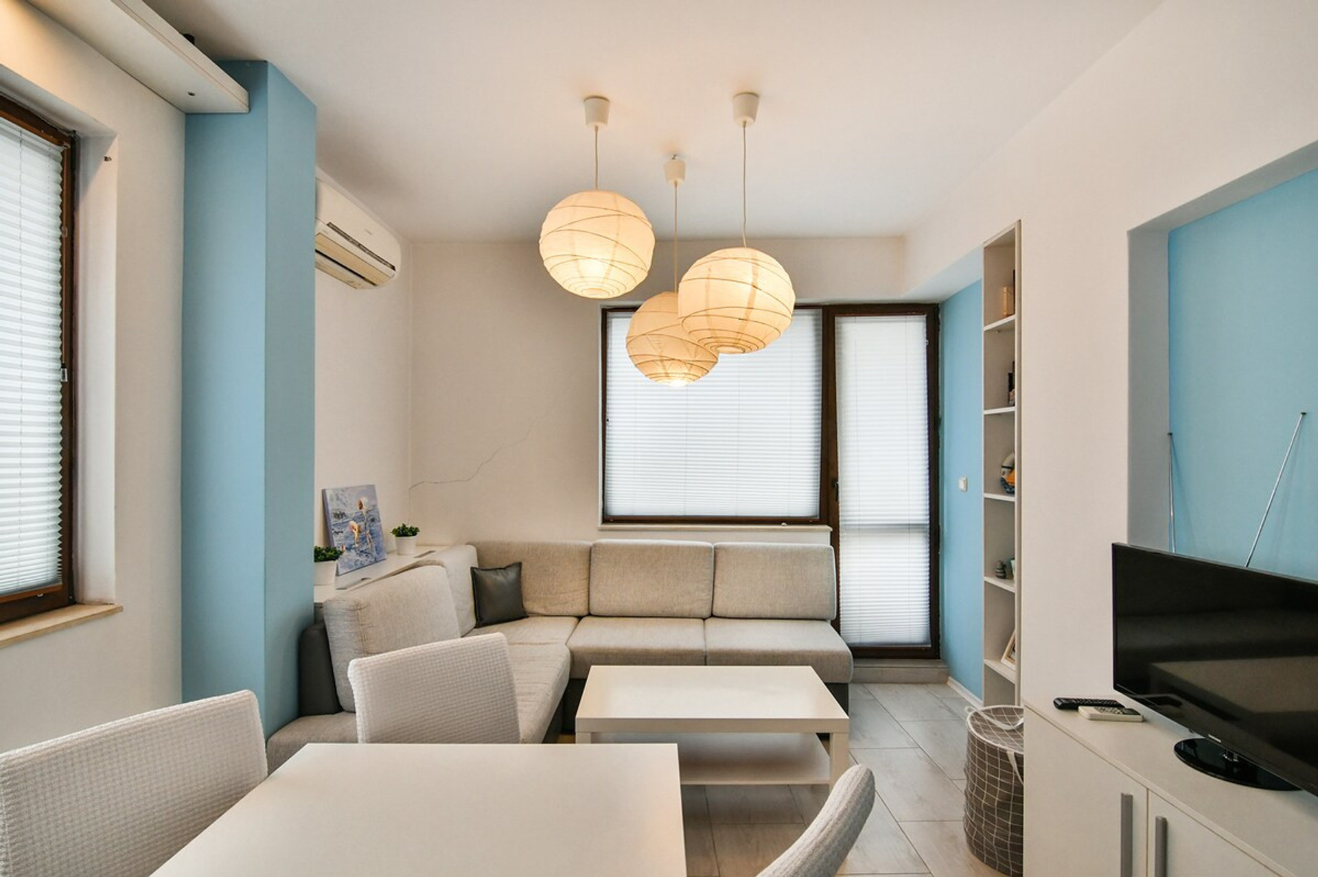 A stylish and comfortable living area with modern furnishings, soft lighting, and a relaxing atmosphere. Ideal for cozy evenings, whether you're watching TV or sharing a meal in the connected dining space.