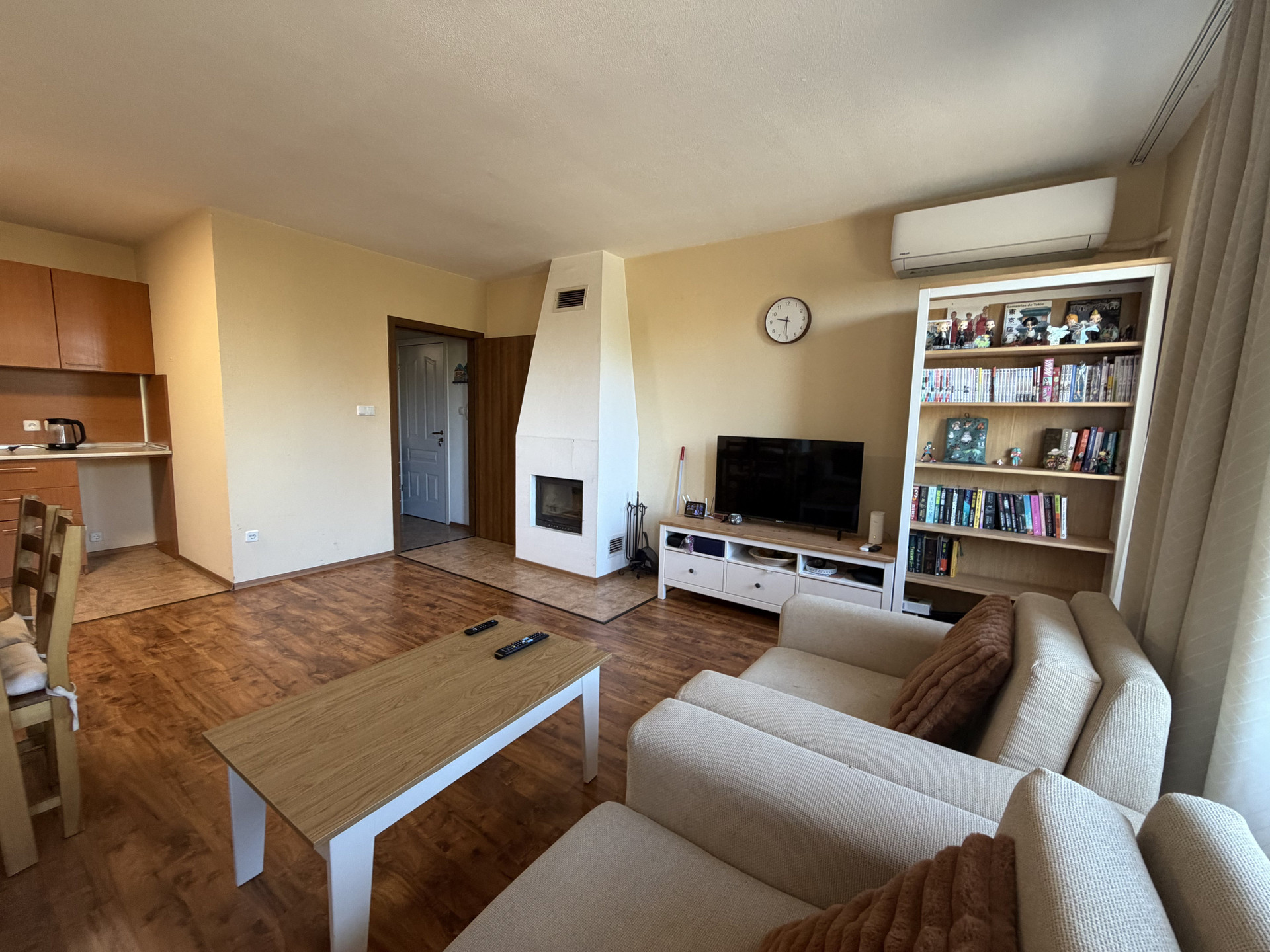 Living room with fireplace and TV