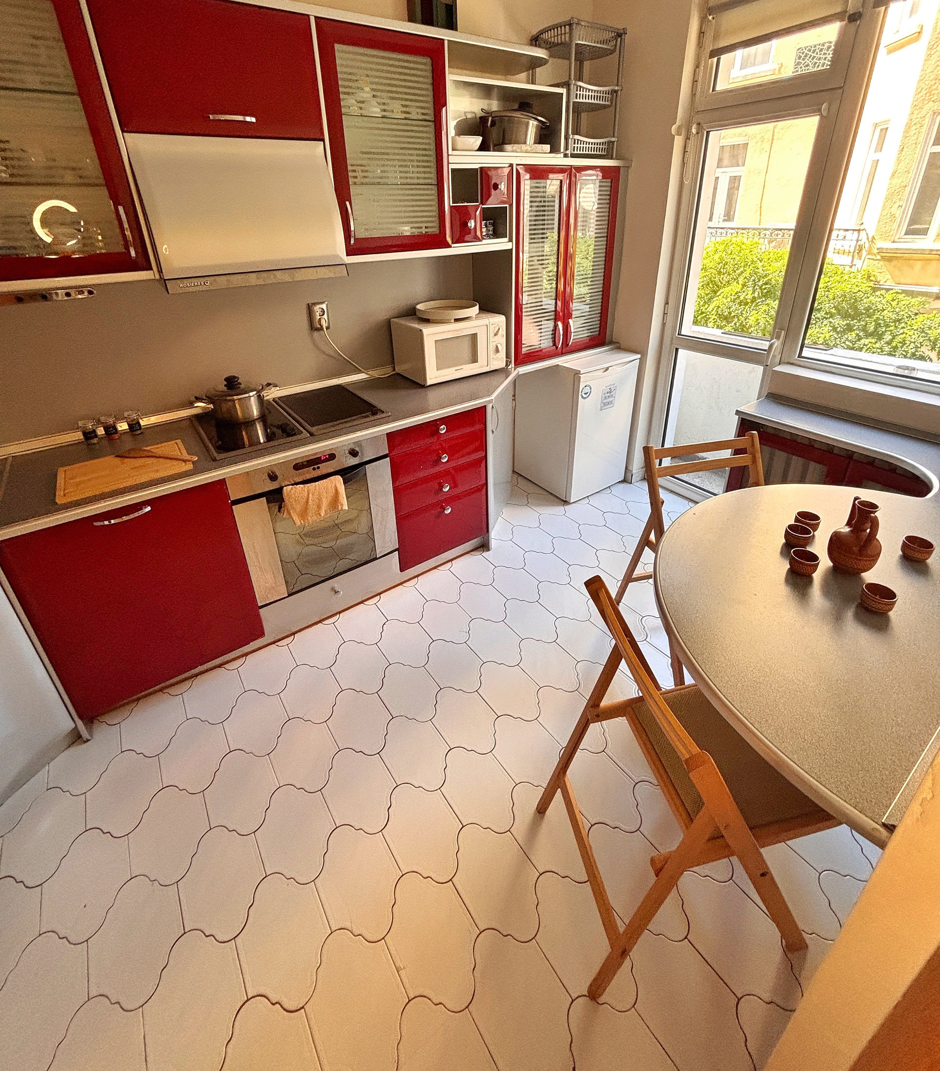 Kitchen with red cabinets and dining table