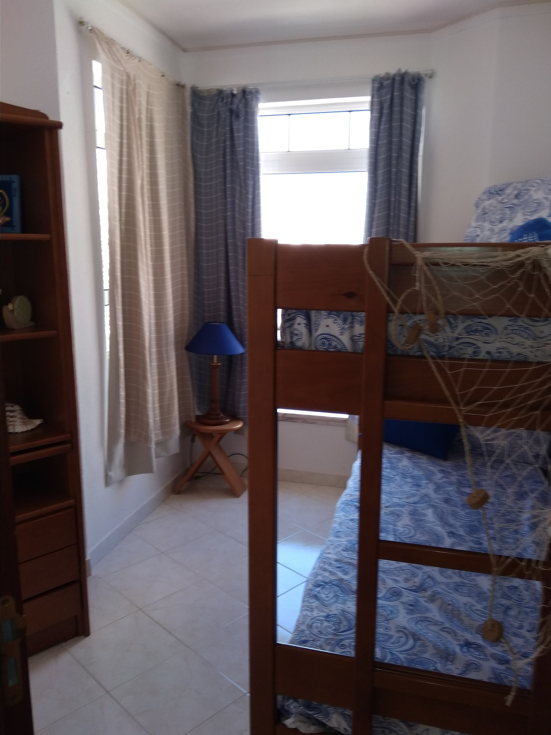 Bunk bed bedroom with bookshelf