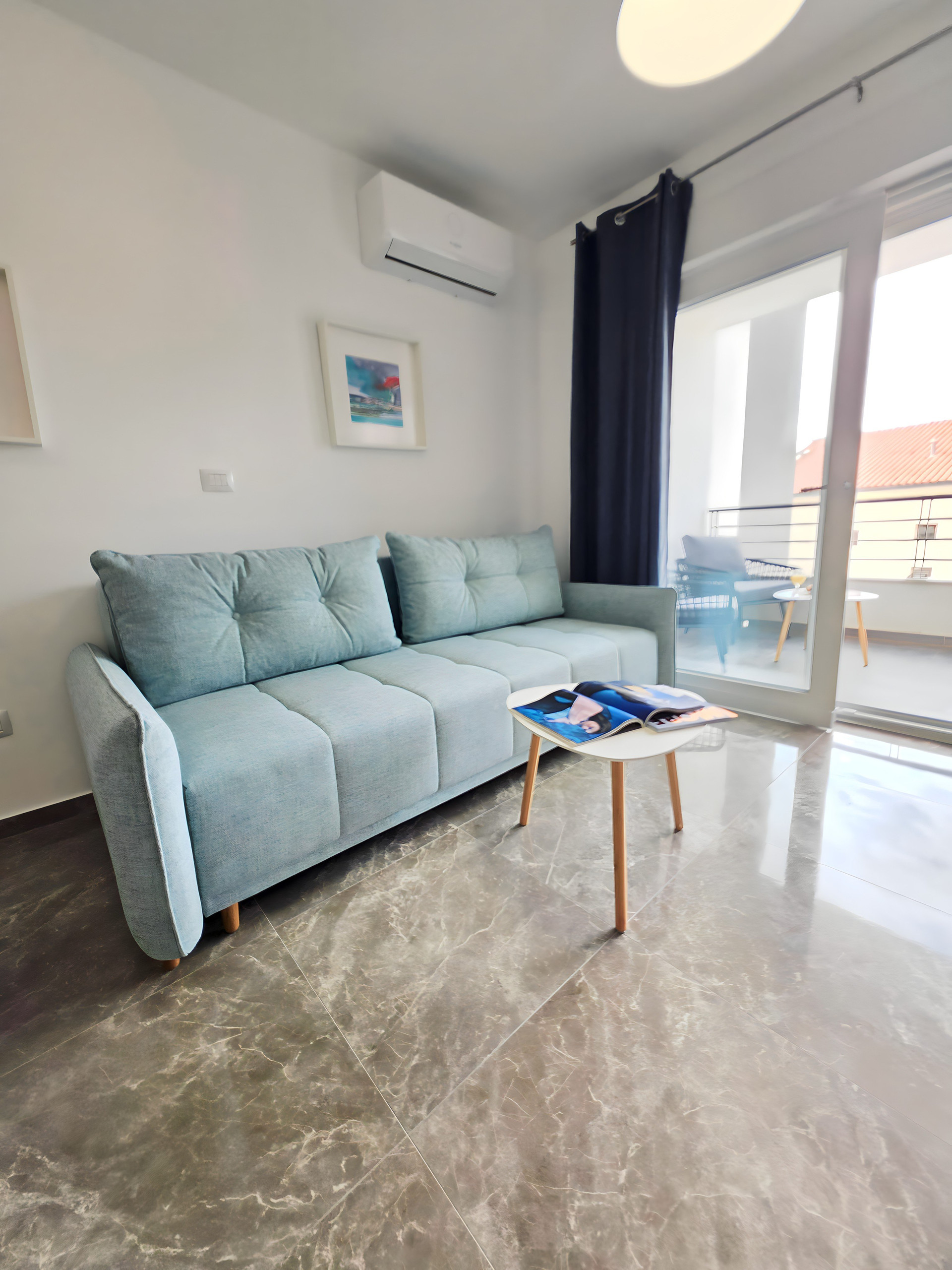 Living room with teal sofa