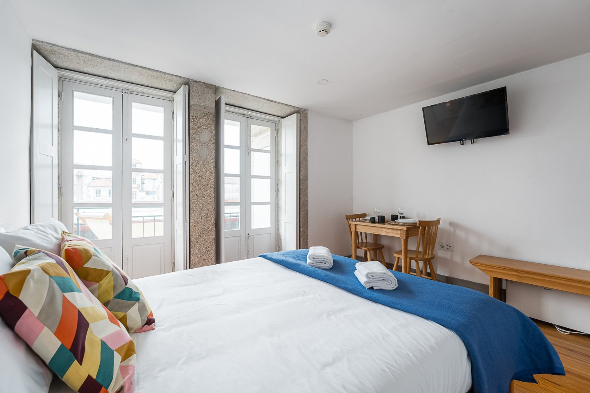 Bright bedroom with TV and table
